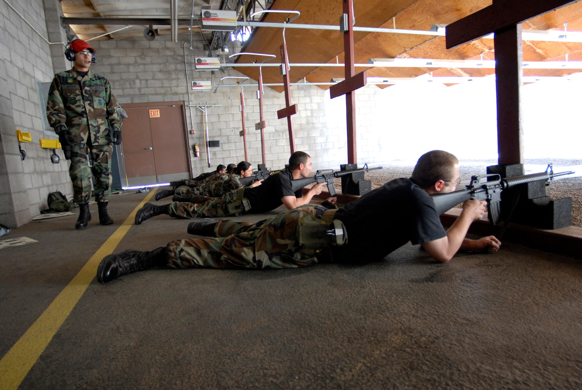 Staff Sgt. Matthew Buchan moniters the Airmen on the firing line for safety infractions and weapon malfunctions April 12 at Luke Air Force Base, Ariz. Sergeant Buchan is a combat arms instructor for the 56th Security Forces Squadron. Airmen must be qualified in their primary weapon prior to deploying in support of the war on terrorism. There are more than 28,000 Airmen deployed around the world today. (U.S. Air Force photo/Senior Airman Christopher Hummel)
