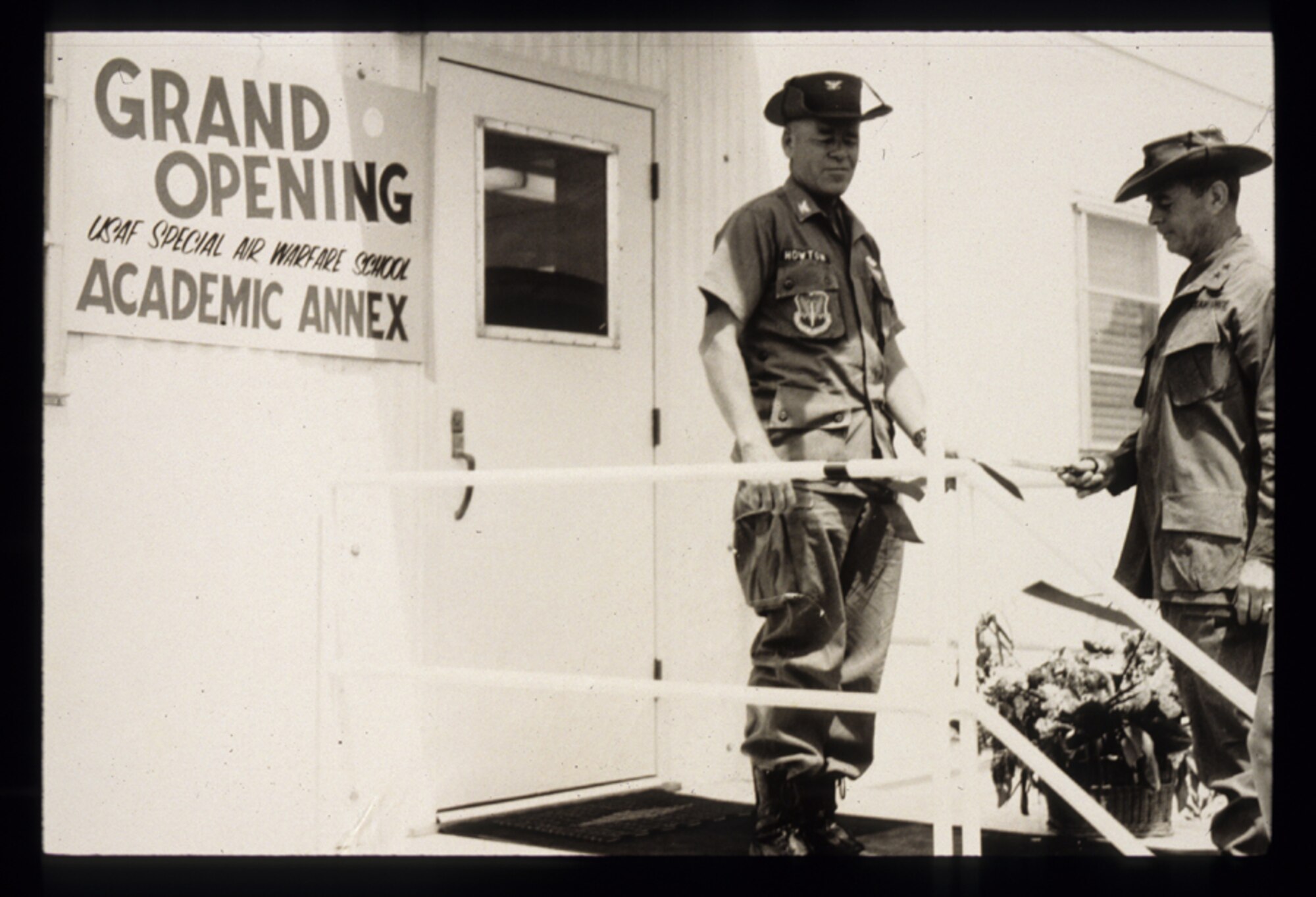 Col. Harry Howton (left), commander of the United States Air Force Special Operations School at the time of its opening, cuts the ribbon for the schoolhouse 40 years ago. Back then, it was known as the Special Air Warfare School. (Courtesy photo)