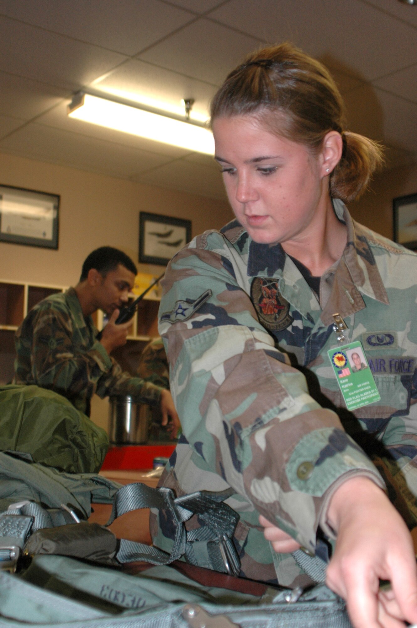 Airman Katrina Kane breaks down aircrew gear during Red Flag-Alaska 07-1 April 11 at Eielson Air Force Base, Alaska. Red Flag-Alaska is a Pacific Air Forces-directed field training exercise flown under simulated air combat conditions. It is conducted on the Pacific Alaskan Range Complex with air operations flown out of Eielson and Elmendorf Air Force bases. Airman Kane is a 61st Fighter Squadron life support specialist. (U.S. Air Force photo/Tech. Sgt. William Farrow)
