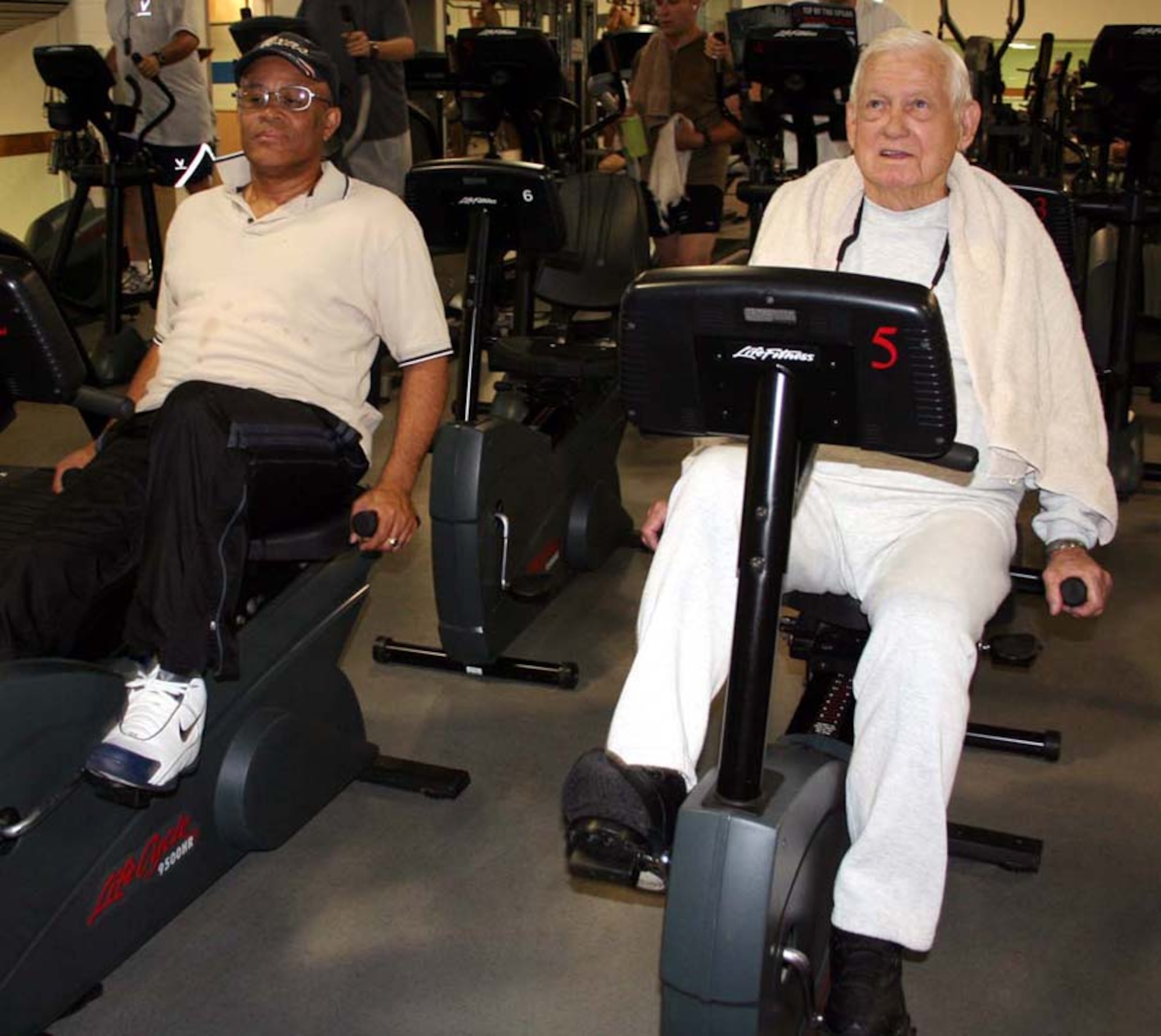 Joseph Caruth (left) and retired Brig. Gen. Harry Aderholt spin on the bicycles during their daily workout at the Aderholt Fitness Center. (U.S. Air Force photo by Jamie Haig)