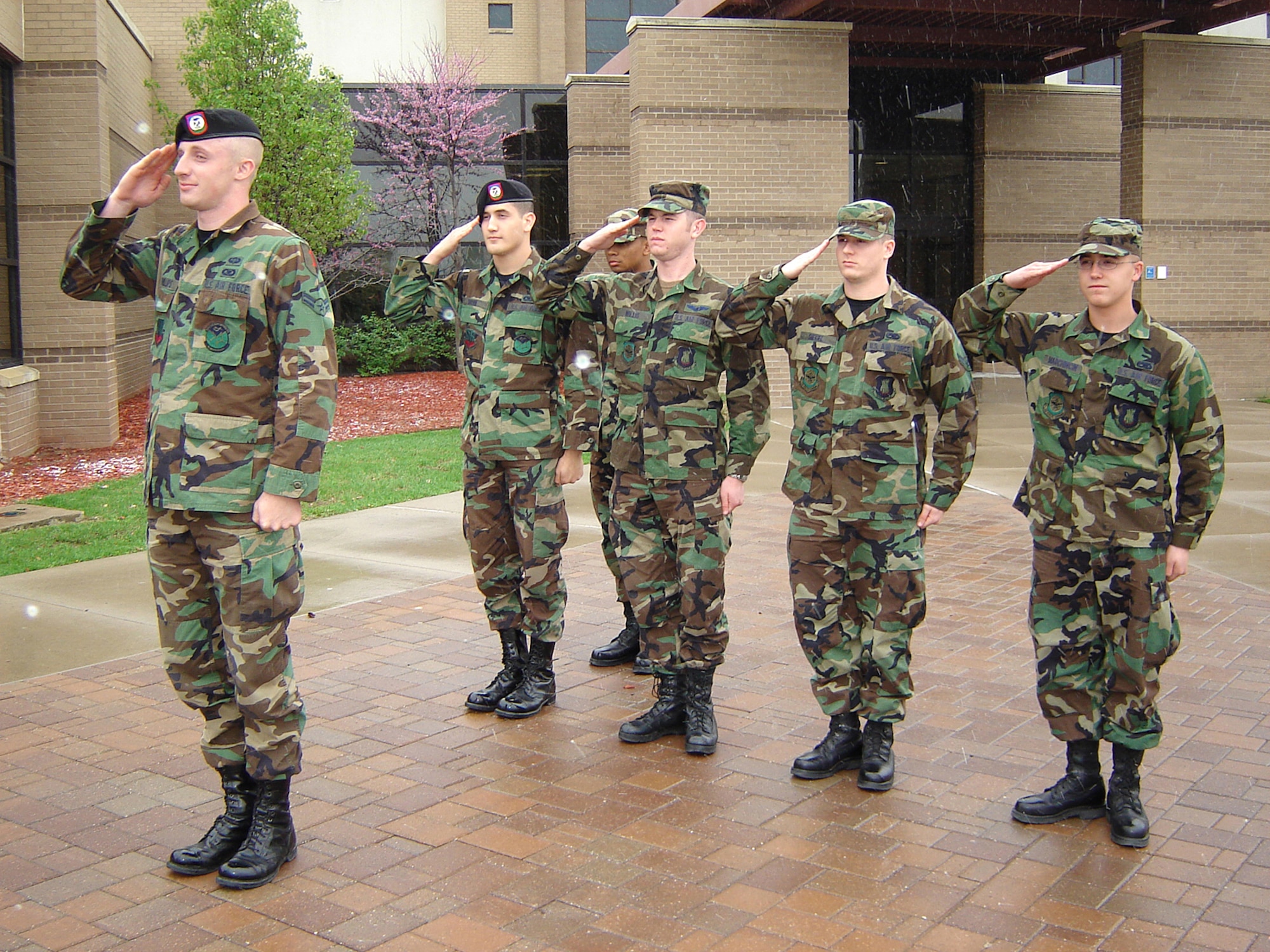 First Term Airman's Center students render proper customs and courtesies April 6 during a Retreat ceremony at the Dole Center flag pole. Airmen are outside and in uniform during Retreat should face the flag, or the sound of music, and stand at the position of parade rest. Then, upon the first note of the national anthem, Airmen should snap to attention and salute. Airmen remain in this position until the last note or music sounds. People driving around base when Retreat begins to play should bring their vehicles to a complete stop and sit quietly at attention until the last note of music plays. Airman in civilian clothes who are on base and outdoors during Retreat, should stand at attention and place their right hands over their hearts upon the first note of the national anthem. Airmen in civilian clothes and wearing hats should hold their hats in their right hands over their hearts during the national anthem. (Photo by Airman 1st Class Jessica Lockoski)