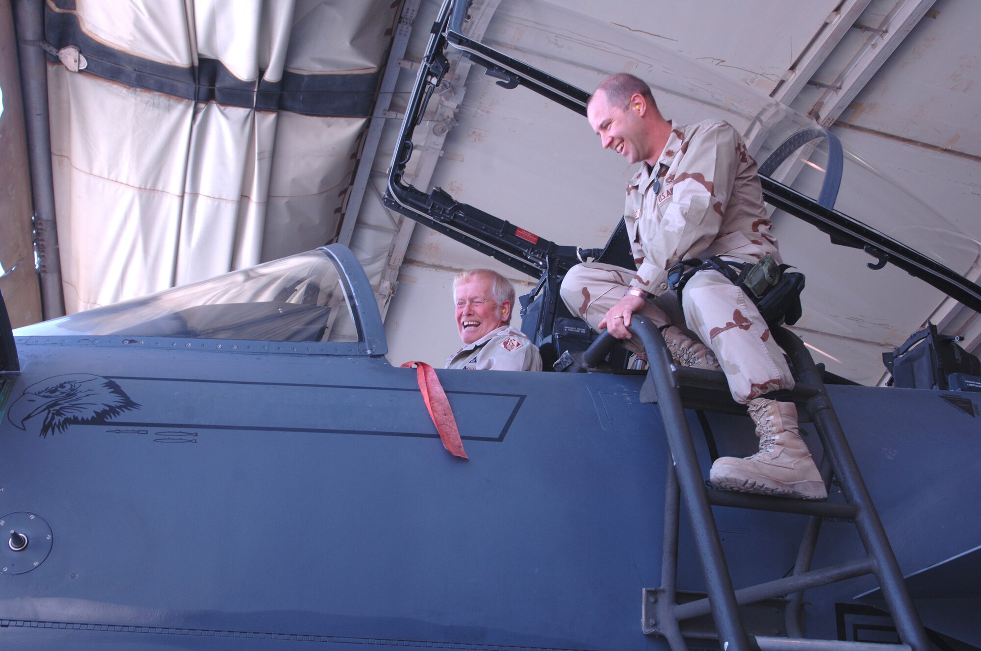 Maj. Patrick Ballard, 455th Expeditionary Maintenance Squadron commander, shows an F-15E cockpit to Skip Steele, a civilian with the Army Corps of Engineers, April 10. (U.S. Air Force photo/Capt. Travis B. Tougaw)
