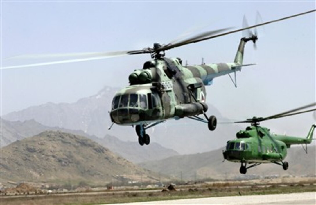 Afghan National Air Corps MI-17 helicopters take off in a formation practice. Air Force mentors assigned to Defense Reform Directorate Air Division under Combined Security Transition Command - Afghanistan provide guidance to soldiers with the Afghan Maintenance Operations Group. 