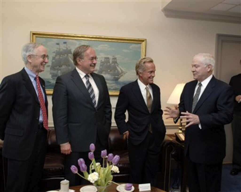Secretary of Defense Robert M. Gates (right) stops by during a meeting with Deputy Secretary of Defense Gordon England (left) and Swiss Minister of Defense Samuel Schmid (second from left) and U.S. Ambassador to Switzerland Peter R. Coneway (second from right) in the Pentagon on April 13, 2007.  England and Schmid are meeting to discuss issues of mutual interest.  