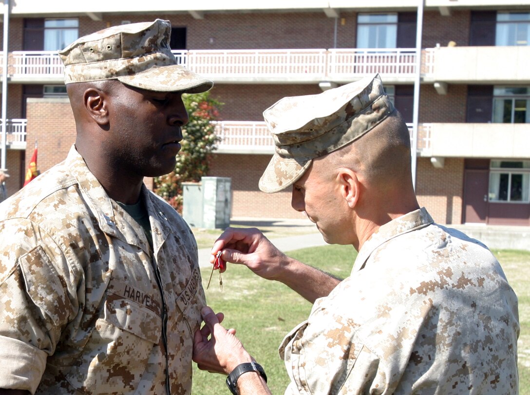 Lt. Col. Matthew G. St. Clair, commanding officer of Battalion Landing Team, 3rd Battalion, 8th Marine Regiment, awards the Bronze Star Medal with Combat Distinguishing Device to Capt. Brian M. Harvey, company commander for Weapons Company, BLT 3/8, during an awards ceremony held aboard Camp Lejeune April 13, 2007. BLT 3/8 is set to deploy as the 22nd Marine Expeditionary Unit's Ground Combat Element. (U.S. Marine Corps Photo by Lance Cpl. Christopher Sam Vega)