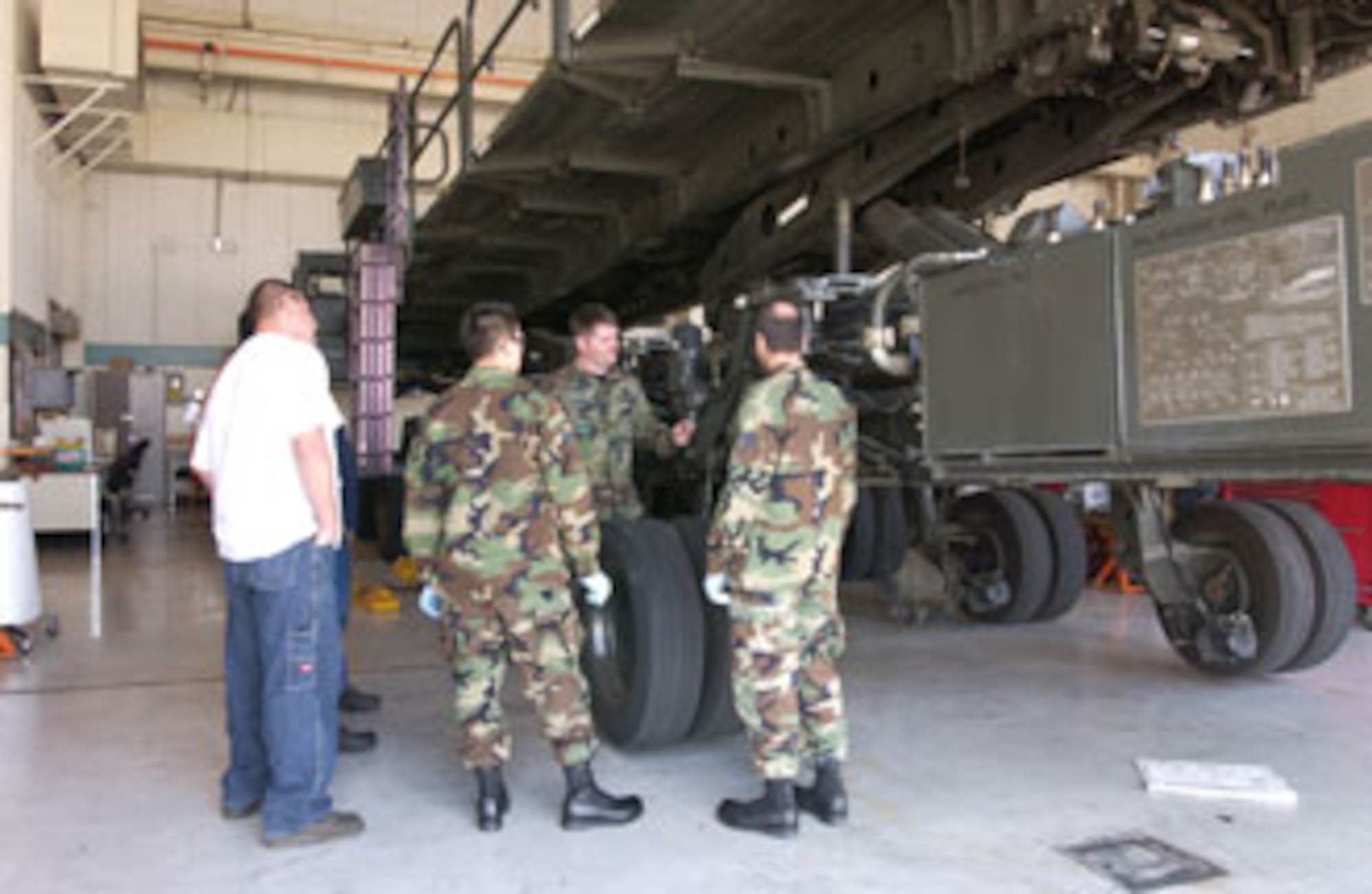 Technical Sgt. David Smith (facing camera), a materiel handling equipment instructor, gives students hands on training for the Tunner 60K loader at March Air Reserve Base, Calif. (U.S. Air Force photo by Staff Sgt. Amy Abbott)