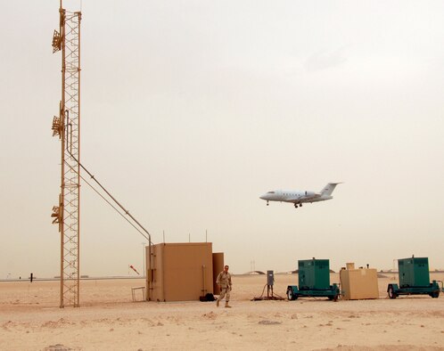 A modified CL-60 Challenger aircraft, flown by Airmen from the Air Force Flight Standards Agency, flies a low level approach past the new Instrument Landing System antenna Tuesday. The aircrew used on-board instrumentation to calibrate the ILS and ensure the navigational aid meets standards. (U.S. Air Force photo by Airman 1st Class Gustavo Gonzalez)