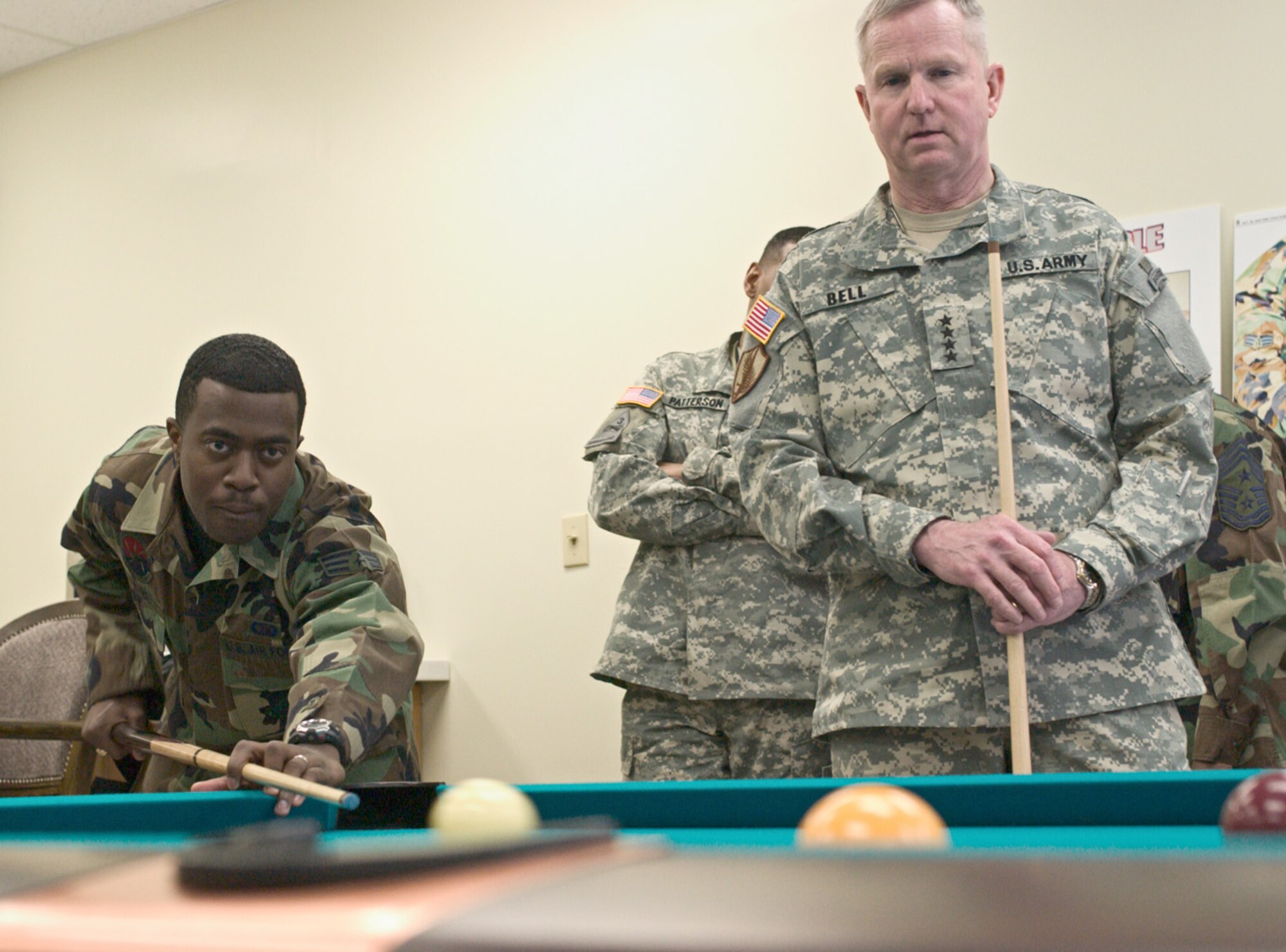 KUNSAN AIR BASE, Republic of Korea  April 10, 2007 -- Senior Airman Bernard Byer, 8th Communications Squadron and Airmen Committed to Excellence president, shoots for the side pocket while playing a game of pool against Gen. B.B. Bell April 10 at the Wolf's ACE in the Hole here. Gen. Bell visited the base for the second time, seeing Airmen and Soldiers perform their mission prior to the base's Operational Readiness Inspection. The general's trip also focused on the concerns and issues the Airmen and Soldiers faced during an assignment at Kunsan. (U.S. Air Force photo/Senior Airman Barry Loo) 