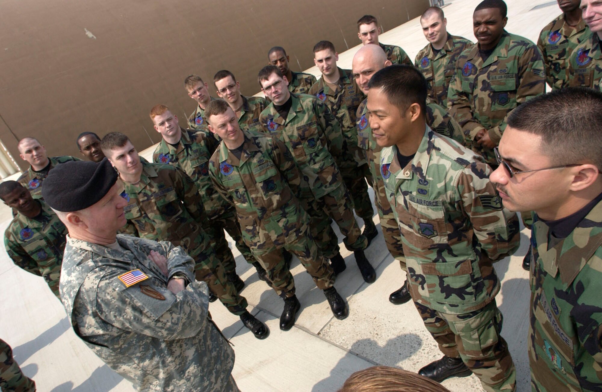 KUNSAN AIR BASE, Republic of Korea  April 10, 2007 -- Gen. B.B Bell, United States Forces Korea commander, talks with members of the 8th Civil Engineer Squadron April 10. Gen. Bell asked questions several Airmen question on how they are supporting the base's expansion program. Gen. Bell later said "the plans to incorporate the two services into one, cohesive operation are very impressive." (Air Force photo/Senior Airman Barry Loo)                                