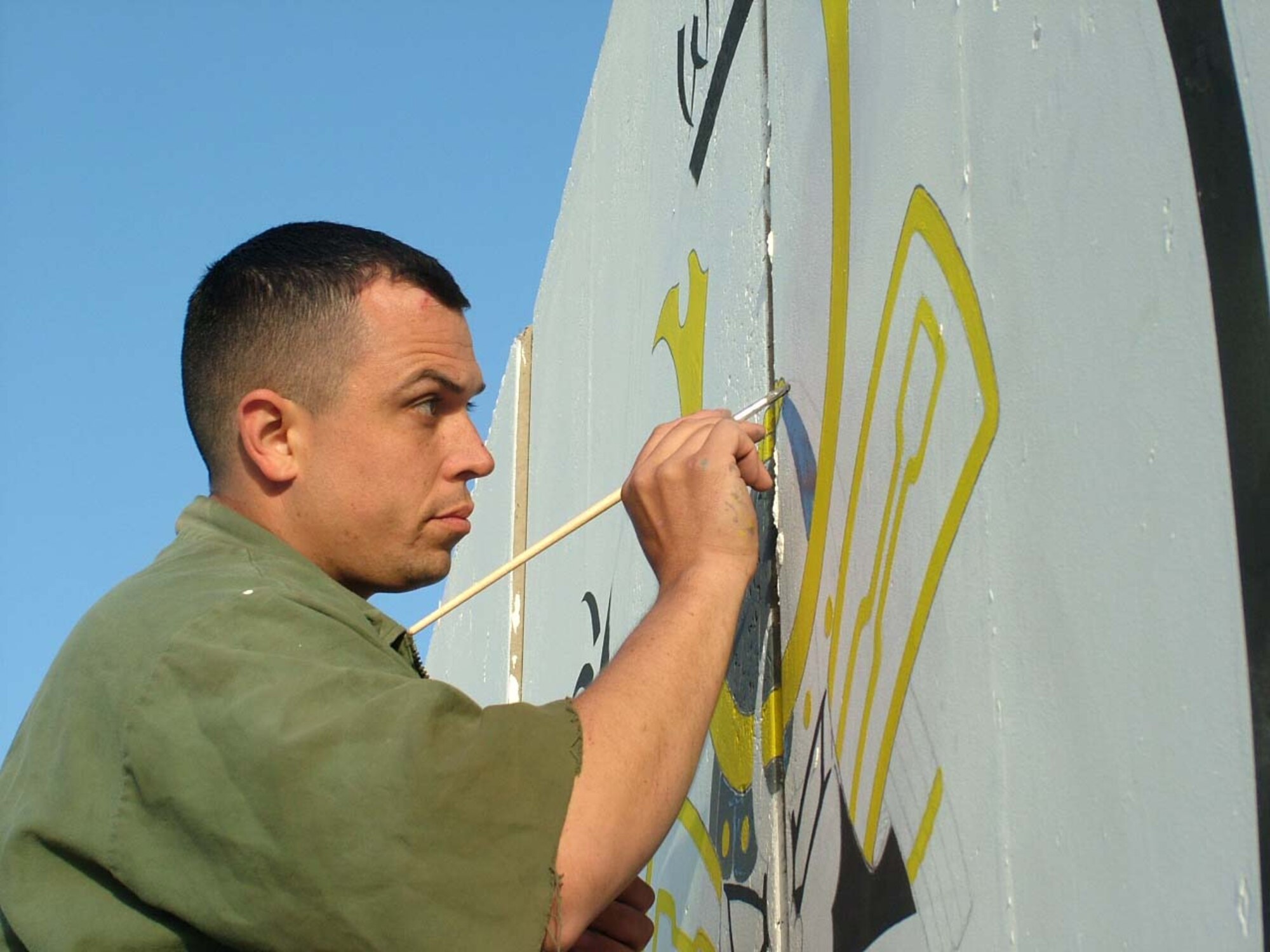 070412 -- BALAD AIR BASE, Iraq -- Tech. Sgt. John Alsvig, 332nd Expeditonary Maintenance Squadron, takes time out of his busy schedule to leave a little "Samauri Wood" footprint on barriers around Balad. (Courtesy photo)