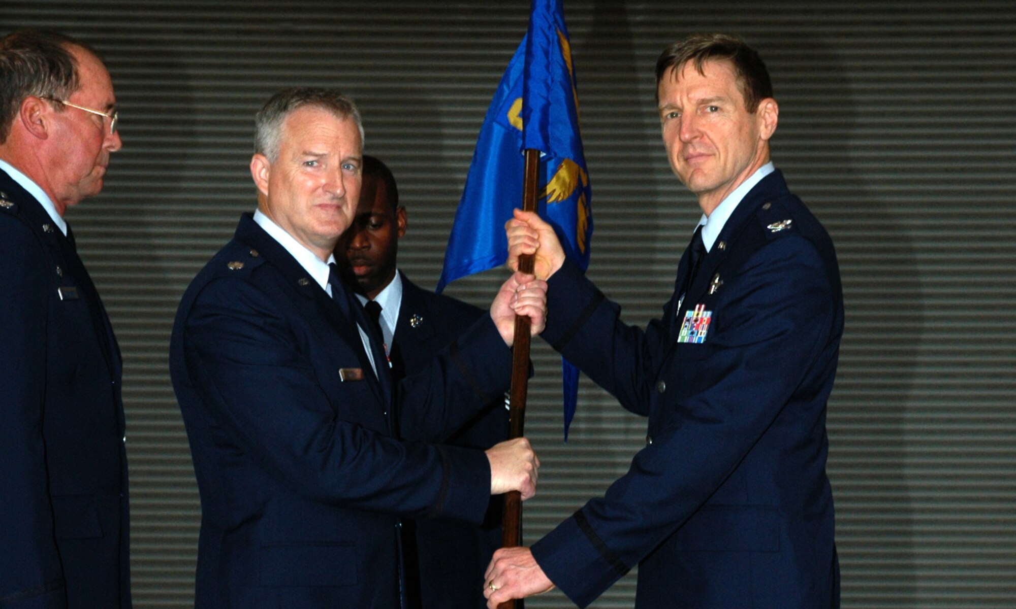 Lt. Col. Tim McCoy (center) accepts the unit flag and therefore command of the 940th Mission Support Group from Col. Albert Reif (right), 940th Air Refueling Wing commander, during a ceremony April 14, 2007 at Beale Air Force Base, Calif.  Col. Mike Higginson (left) relinquished command of the 940th MSG and retired from the Air Force Reserve that same day. (U.S. Air Force photo/Staff Sgt. Luke Johnson)