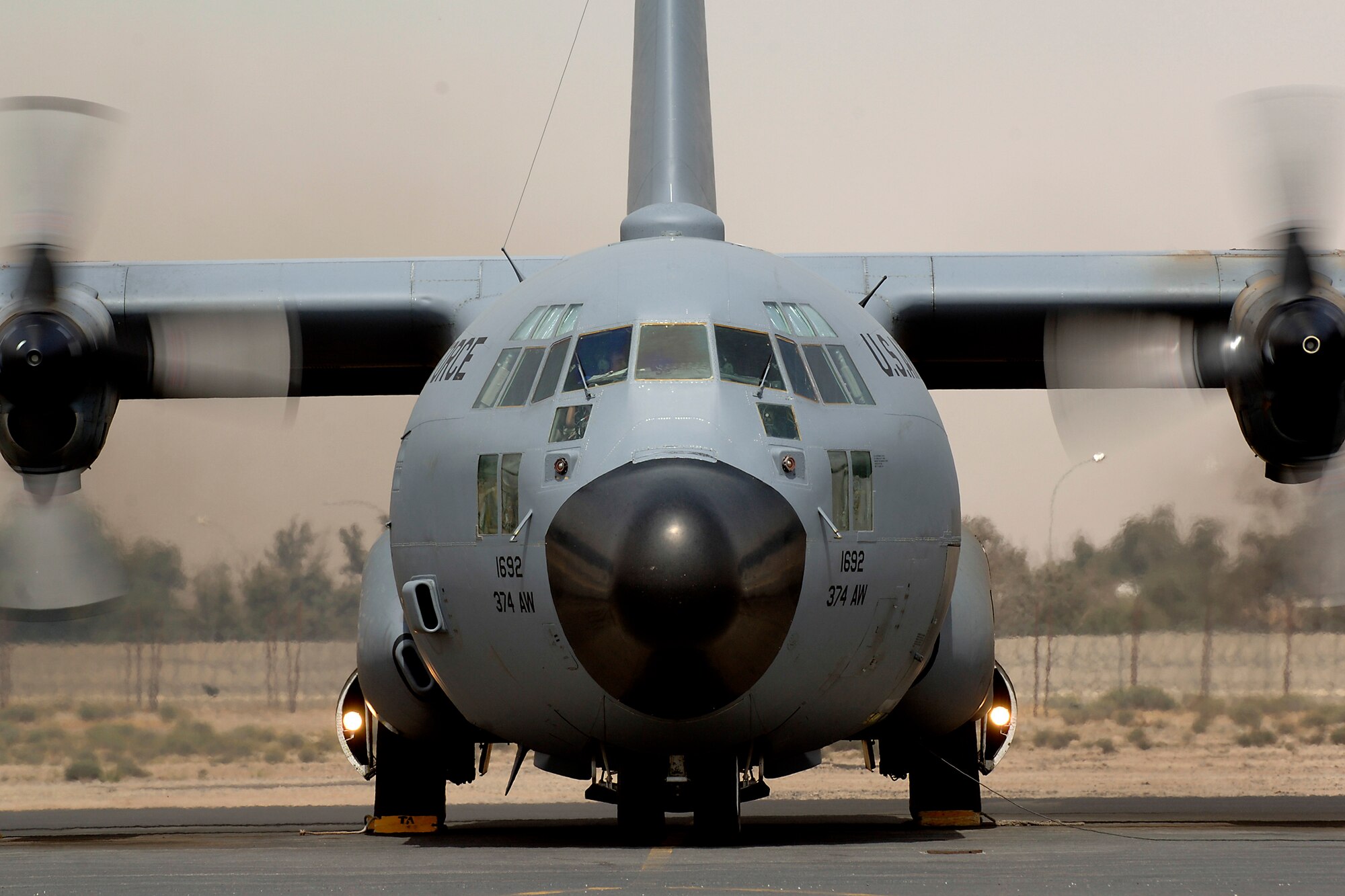 A C-130 from the 386th Air Expeditionary Wing prepares to taxi out and fly another mission into Iraq while a dust storm invades the background at an undisclosed location in Southwest Asia on 21 March 2007. (U.S. Air Force photo/Tech. Sgt. Edward D. Holzapfel) 