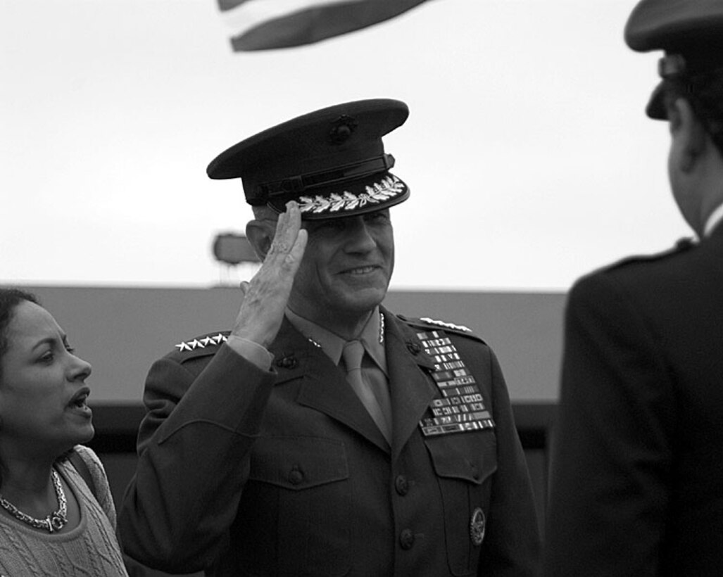 Marine Corps Gen. Charles Wilhelm, commander in chief of the U.S. Southern Command, salutes a Peruvian military officer during a reception at the Lima, Peru, airport Nov. 30, as his translator, Nilda Fitzgerald, left, assists communication. Wilhelm's visit to Peru included meetings with political and military leaders to discuss counterdrug operations and an ongoing border dispute between Peru and neighboring Ecuador. Douglas J. Gillert