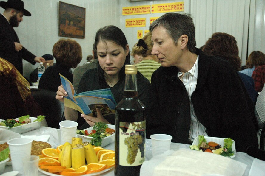 Airman 1st Class Rochel Leah Goldblatt, deployed from Spangdahlem Air Base, shares Passover withTech. Sgt. Christine Paille at a Jewish Community Center in Bishkek, Kyrgyzsrtan. The Manas Air Base Chapel Staff worked closely with Force Protection, the Wing Leadership, and a local Synagogue to arrange for Jewish personnel to take part in the Passover service. (Air Force Photo/Master Sgt. Daniel Nathaniel) 