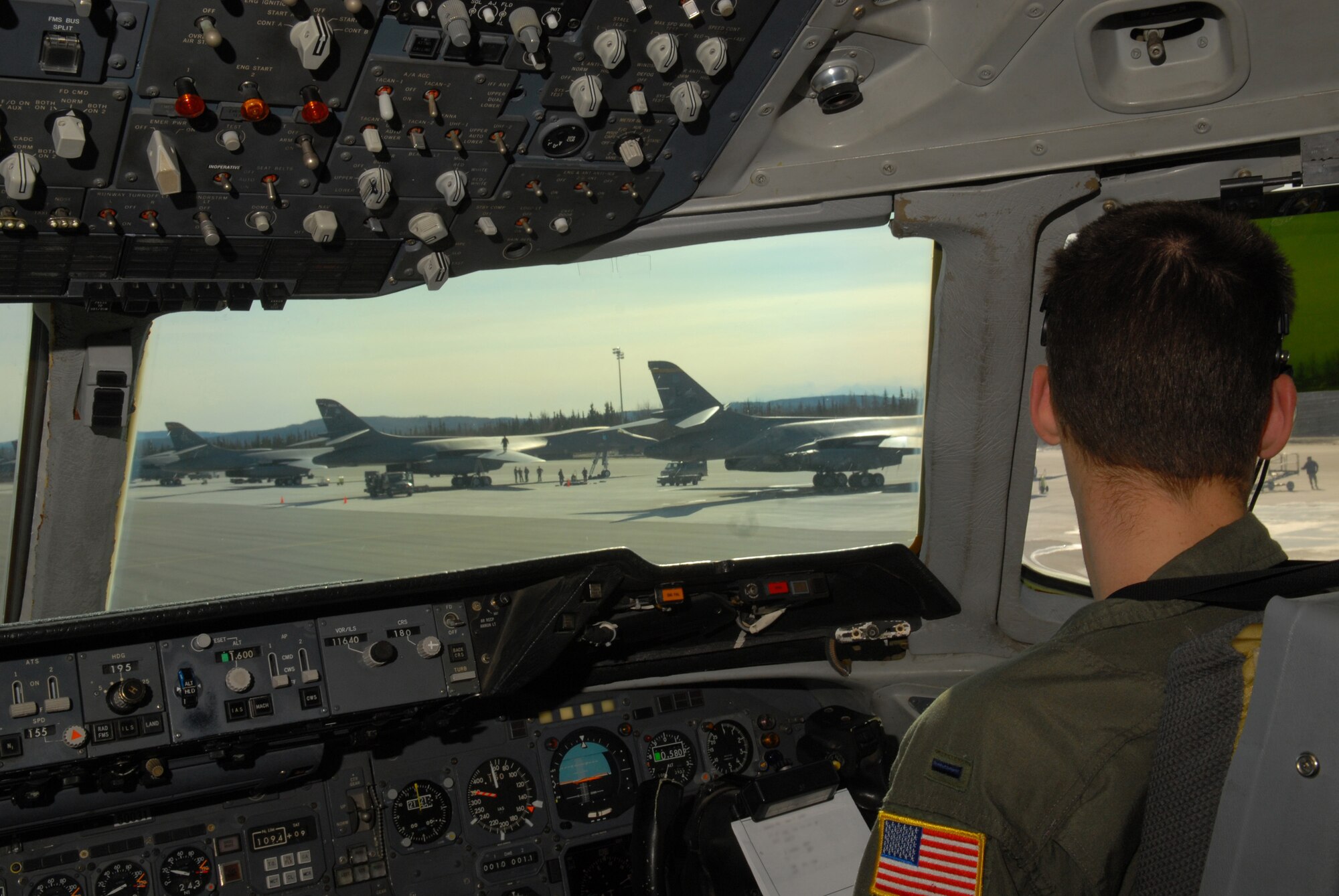 EIELSON AIR FORCE BASE, Alaska -- 1st  Lt. Ryan Maclean, 6th Air Refueling Squadron, Travis AFB, C.A., looks at the B-1B Lancer from Ellsworth Air Force Base, S.D., while taxiing a KC-10 Extender on the flightline on April 16 during Red Flag-Alaska 07-1. Red Flag-Alaska is a Pacific Air Forces-directed field training exercise for U.S. forces flown under simulated air combat conditions. It is conducted on the Pacific Alaskan Range Complex with air operations flown out of Eielson and Elmendorf Air Force Bases. (U.S. Air Force Photo by Airman 1st Class Jonathan Snyder)