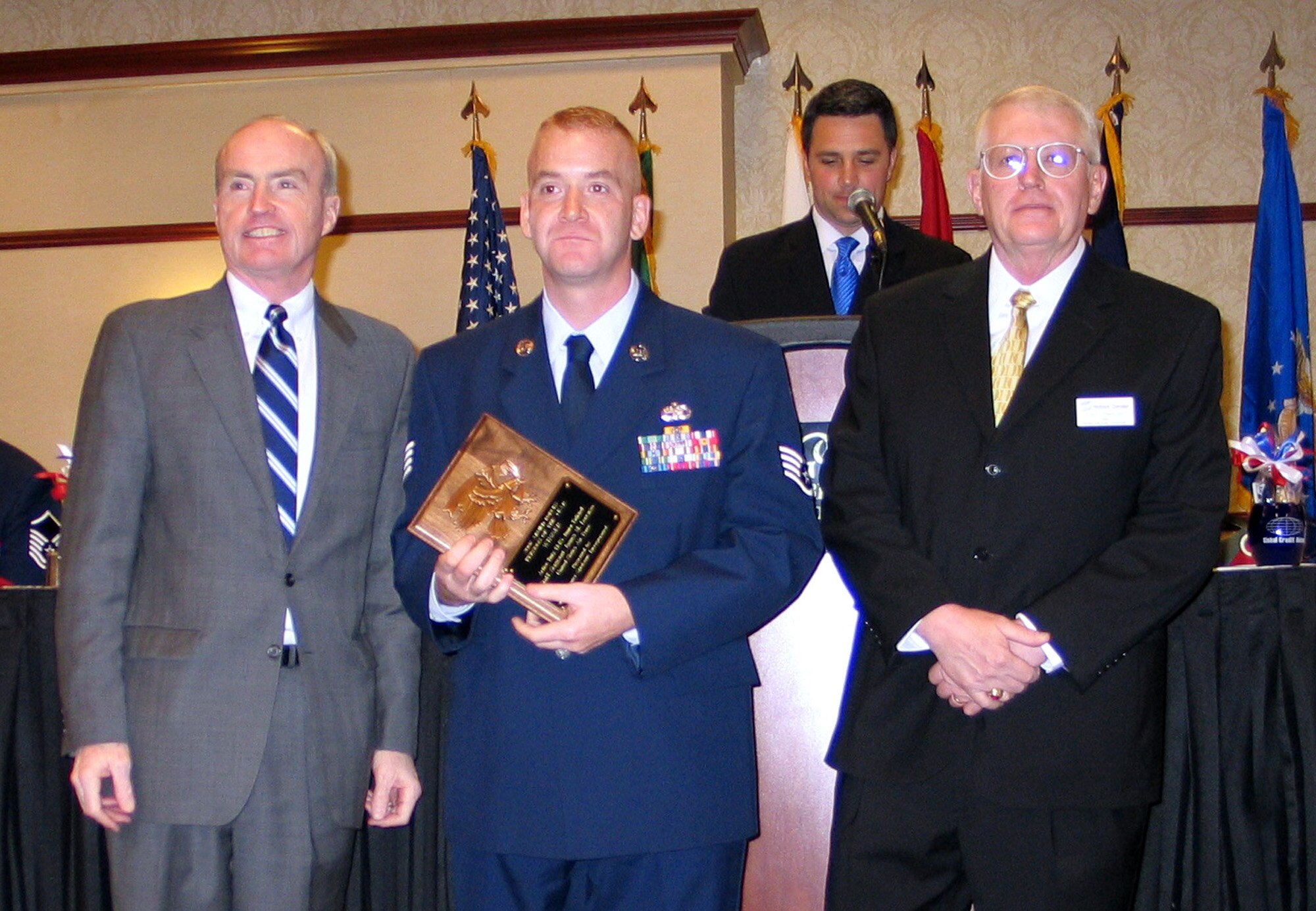 FAIRCHILD AIR FORCE BASE, Wash. -- Staff Sgt. James Lorenzo, 92nd Logistics Readiness Squadron, accepts his Person of the Year plaque from Spokane Mayor Dennis Hession (left) and Fred Zitterkopf, Armed Services Committee chairman, April 12 at the 51st Annual Armed Forces Persons of the Year banquet, hosted by Greater Spokane Incorporated. The award honors excellent servicemembers who excel in their community service efforts. (U.S. Air Force photo/Staff Sgt. Connie L. Bias) 
