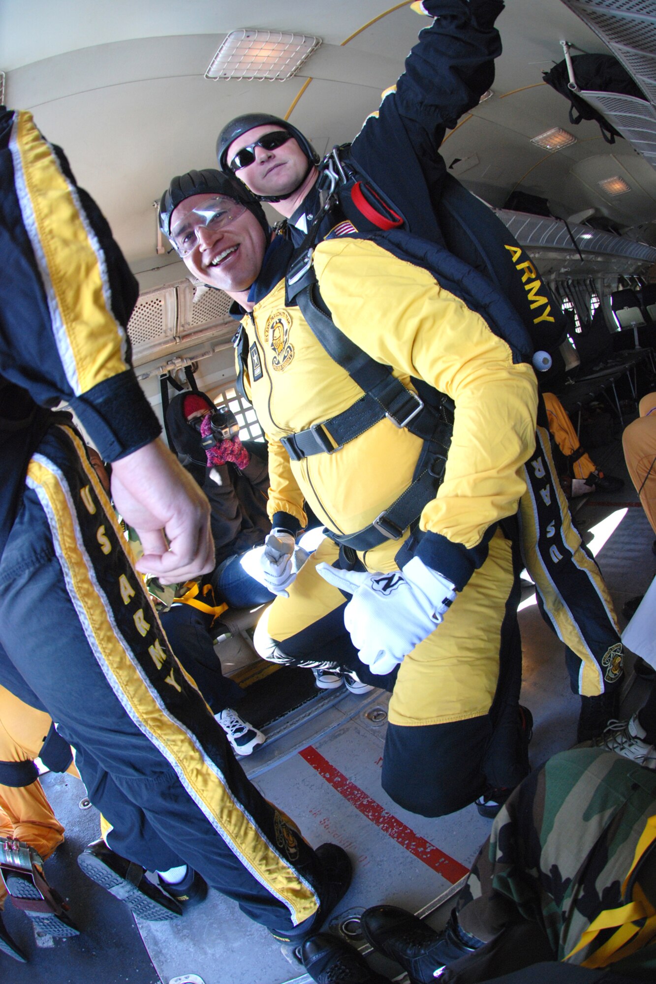 OVER EGLIN AIR FORCE BASE, Fla. -- U.S. Army Staff Sgt. Joe Jones, tandem team freefall videographer, leads Bill Pearson, Channel 3 out of Pensacola, Fla., to the rear of the C-41 for his first leap from an airplane in a tandem jump with the U.S. Army Parachute Team "Golden Knights" aerial demonstration team April 14 at the Eglin air Show practice. The practice show was the only jump the team made due to an April 15 severe weather cancellation of the air show and winds exceeding 20 mph gusts April 16. Sergeant Jones has logged more than 3,500 freefall jumps, 400 tandem and 50 military static line jumps in his military career. (U.S. Air Force photo by Staff Sgt. Mike Meares)
