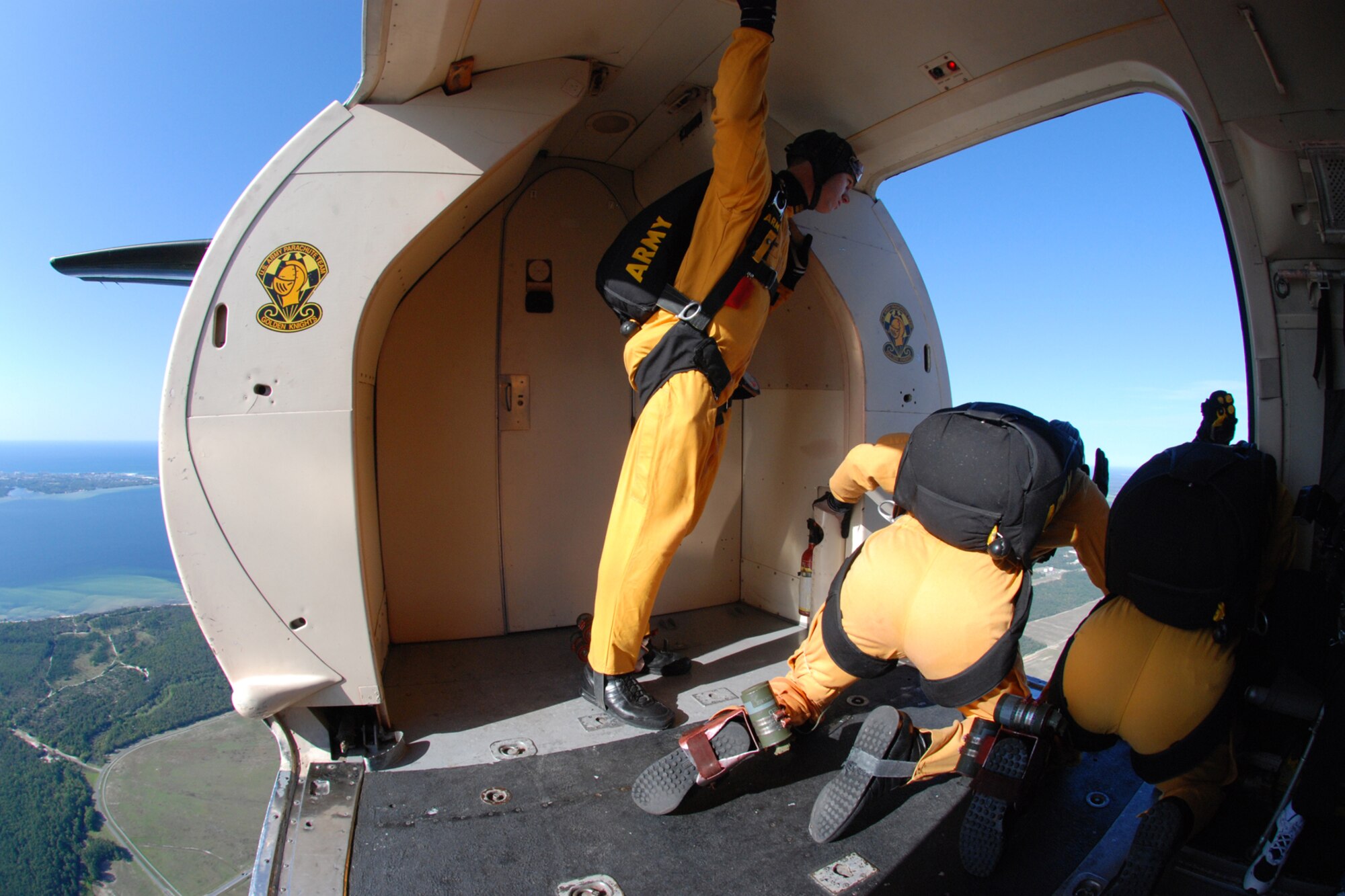 OVER EGLIN AIR FORCE BASE, Fla. -- Three members of the U.S. Army Parachute Team "Golden Knights" aerial demonstration team watch the drop zone below over Eglin to determine the wind directions just before their practice show jump April 14. The practice show was the only jump the team made due to an April 15 severe weather cancellation of the air show and winds exceeding 20 mph gusts April 16.  (U.S. Air Force photo by Staff Sgt. Mike Meares)
