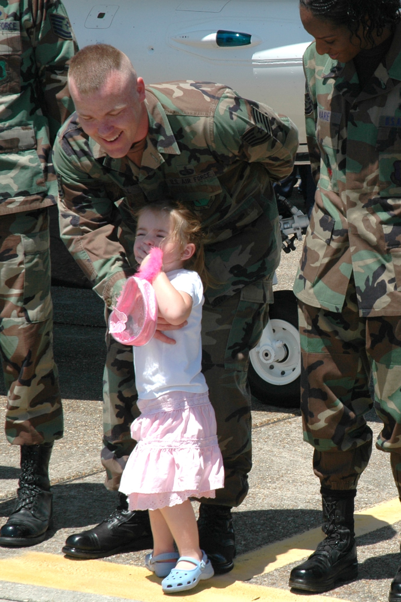 EGLIN AIR FORCE BASE, Fla. -- Tech. Sgt. Roger Mitchell, 29th Training Systems Squadron, redirects his daughter back to his wife in the moments before his re-enlistment ceremony April 14. Lt. Col. Kevin Robbins, U.S. Air Force Thunderbird commander, administered the enlisted oath to seven Eglin members before the Eglin practice air show. The other Eglin members re-enlisting in the Air Force are: Tech. Sgt. Travis L. Harrington, 46th Weather Squadron; Tech. Sgt. Destry Skweres, 96th Logistics Readiness Squadron; Staff Sgt. Chassity Ware, 33rd Maintenance Group; Staff Sgt. Cory Riley, 780th Test Squadron; Staff Sgt. Dale Sowers, 96th Communications Squadron; and Airman 1st Class John Henry, 96th Logistics readiness Squadron. (U.S. Air Force photo by Staff Sgt. Mike Meares)