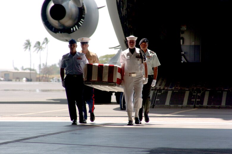 A joint honor guard of Airmen, Soldiers, Marines, Sailors, and Coast Guard rendered honors to six repatriated servicemembers April 12 at Hickam Air Force Base, Hawaii. The Joint POW/MIA Accounting Command held the arrival ceremony for the six, killed in the Korean War.  An official delegation from the United States traveled to North Korea to accept the remains. (U.S. Air Force photo/Staff Sergeant Valda G. Wilson)