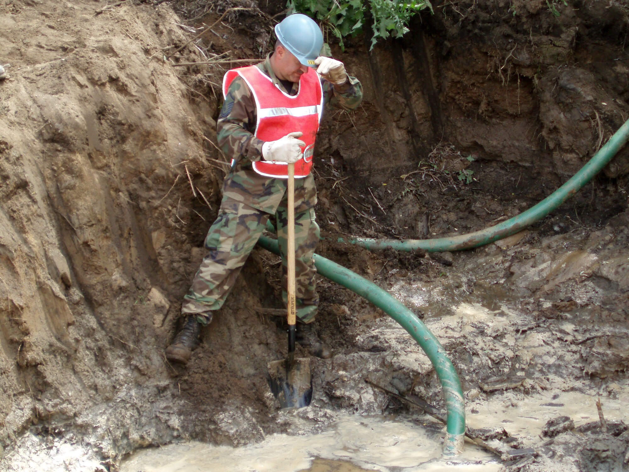 ESCONDIDO, Calif. -- MSgt Moises Zanazanian from the 439th CES, Westover Air Reserve Base, Mass. keeps the intake hose cleared during dewatering operations for a road for the San Pasqual Band of Mission Indians. (U.S. Air Force photo by Capt. Matthew J. Russell, 439th CES)  