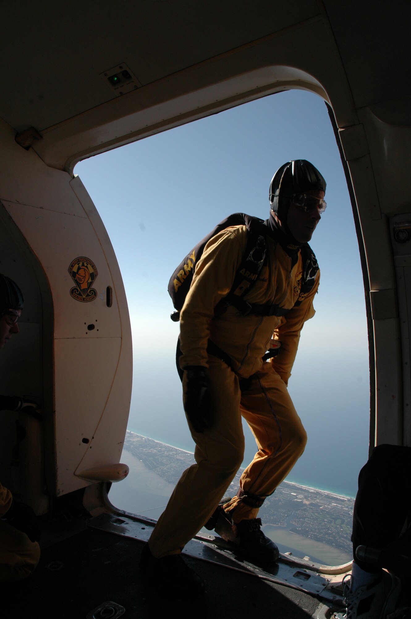 OVER EGLIN AIR FORCE BASE, Fla. -- U.S. Army Sgt. Todd Beckel, Black Demonstration Team narrator, begins his leap out of the C-41 as the first of the demonstration team to exit the plane April 14 during the practice show. Sergeant Beckel saluted the other jumpers as he leaped from the aircraft. The practice show was the only jump the team made due to an April 15 severe weather cancellation of the air show and winds exceeding 20 mph gusts April 16. Sergeant Beckel is in his first year with the Golden Knights and has made more than 500 freefall jumps in his Army career.  (U.S. Air Force photo by Staff Sgt. Mike Meares)
