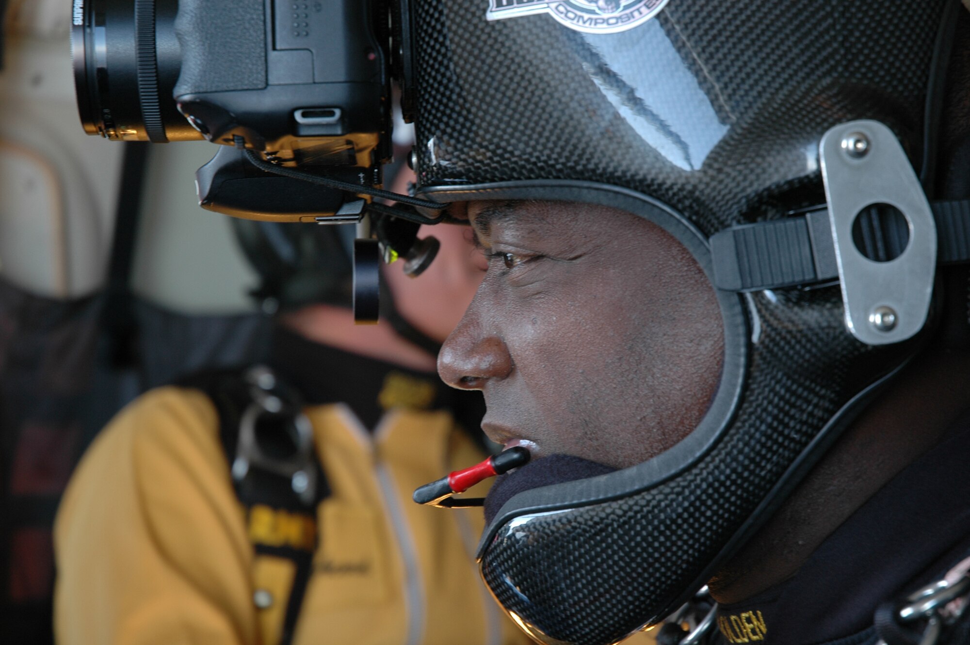 OVER EGLIN AIR FORCE BASE, Fla. -- U.S Army Staff Sgt. Marc Owens, U.S. Army Parachute Team "Golden Knights" aerial demonstration team freefall videographer, watches as fellow members of the team prepare to jump from the C-41 aircraft April 14. Sergeant Owens is wearing a specially designed helmet equipped with a digital camera and a video camera to document the jump over Eglin. The practice show was the only jump the team made due to an April 15 severe weather cancellation of the air show and winds exceeding 20 mph gusts April 16. Sergeant Owens is in his fifth year with the Golden Knights and has made more than 2,000 freefall jumps in his Army career.  (U.S. Air Force photo by Staff Sgt. Mike Meares)