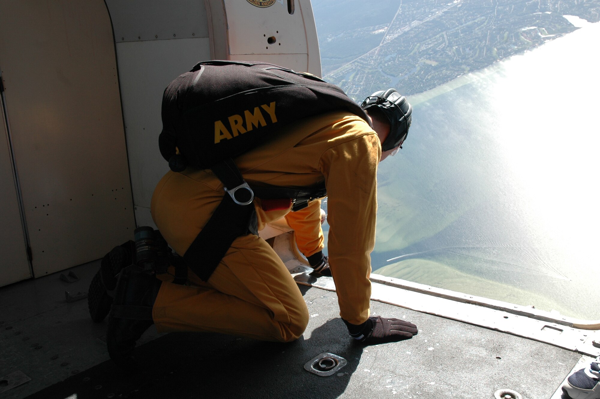 OVER EGLIN AIR FORCE BASE, Fla. -- U.S. Army Sgt. First Class Paul Sachs, U.S. Army Parachute Team "Golden Knights" aerial demonstration team black team leader, takes one final look at the drop zone below the C-41 before being the first of the demonstration team to leap from the plane April 14 during the practice show. The practice show was the only jump the team made due to an April 15 severe weather cancellation of the air show and winds exceeding 20 mph gusts April 16. Sergeant Sachs is in his seventh year with the Golden Knights and has made more than 2,700 freefall jumps and has his High Altitude Low Opening, or HALO, wings. (U.S. Air Force photo by Staff Sgt. Mike Meares)
