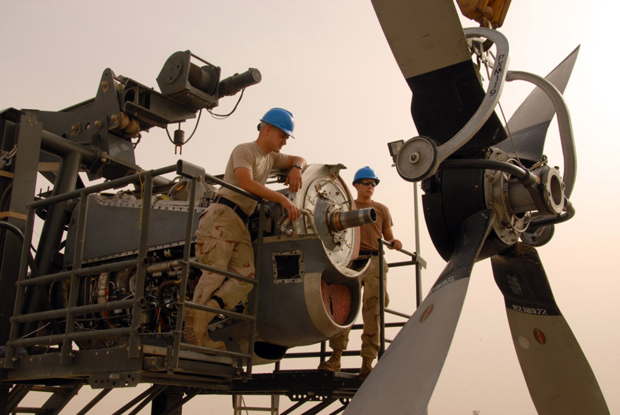 Senior Airmen Philip Adkins (left) and Weldon Medina install a propeller on a C-130 Hercules engine.  The Airmen work in the 379th Air Expeditionary Wing's centralized intermediate repair facility at a deployed location in Southwest Asia and repair C-130 engines sent in from the entire area of responsibility. (U.S. Air Force photo/Airman 1st Class Gustavo Gonzalez)