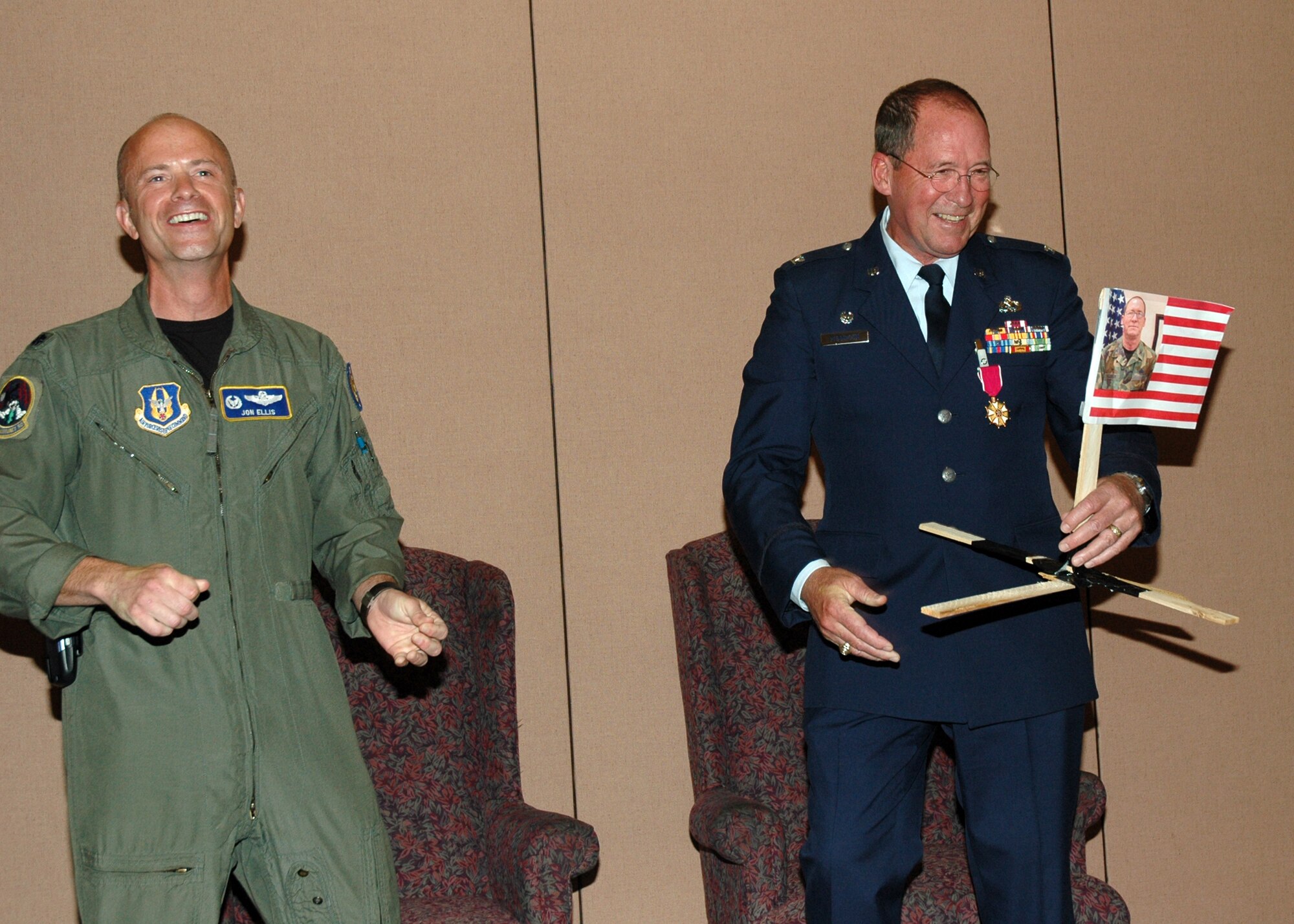 Air Force Reservist Col Mike Higginson (right), accepts a retirement gag gift from Lt. Col. Jon Ellis, 13th Reconnaissance Squadron commander, during a ceremony April 14, 2007 at Beale Air Force Base, Calif.  Colonel Higginson, who was the 940th Mission Support Group commander, culminated a 40-year military career that began as an Airman basic and finished as a colonel. (U.S. Air Force photo/Stacey Knott)   