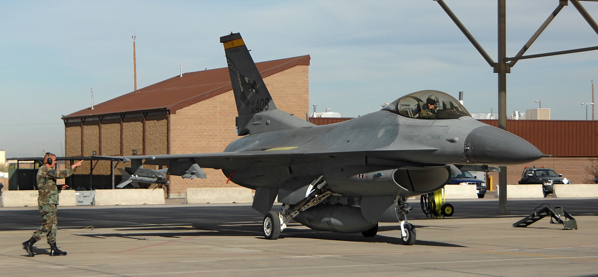 A 150th Fighter Wing crew chief prepares an F-16 for takeoff. (U.S. Air Force photo by Adam Wooten)