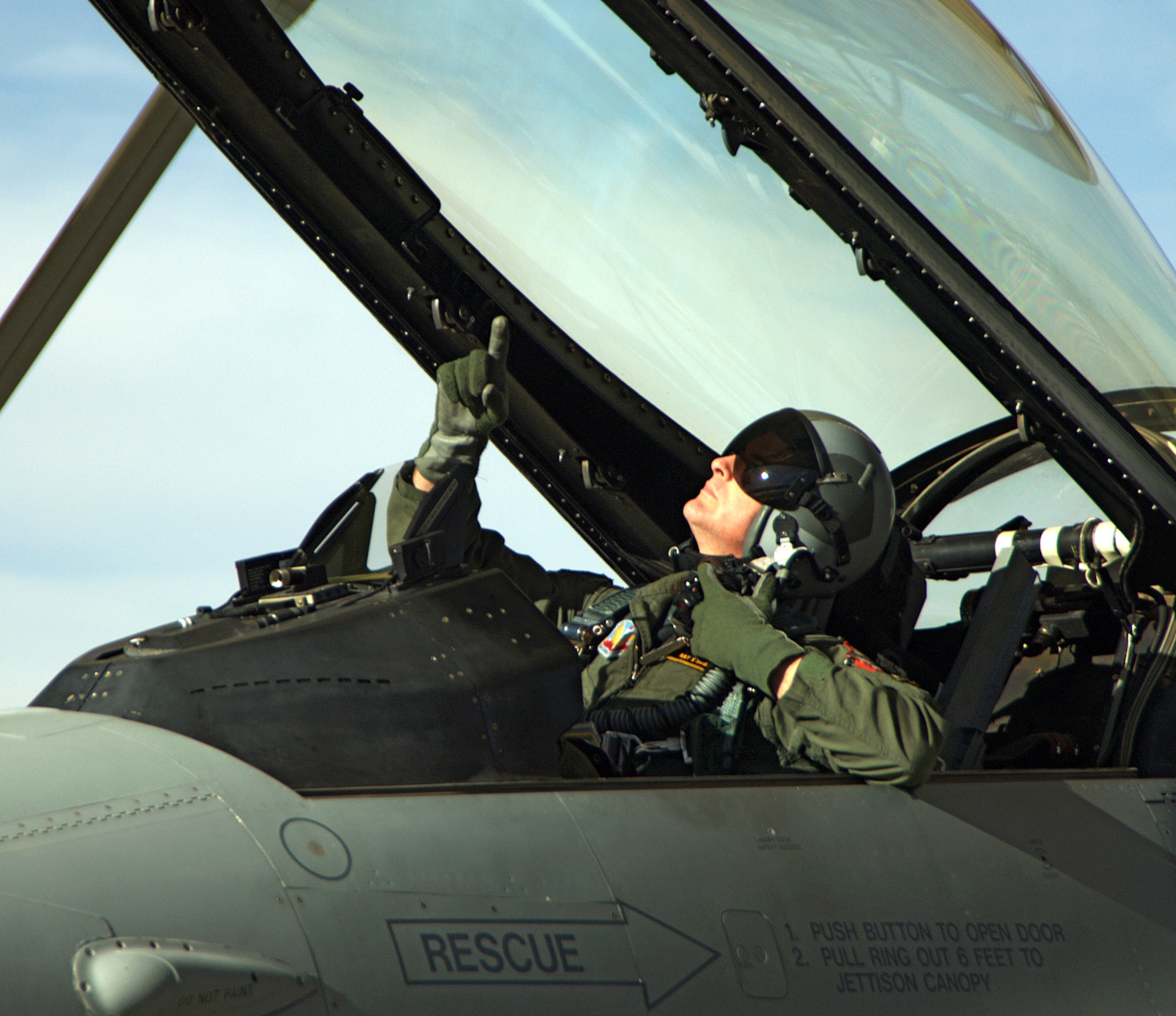 An F-16 pilot here checks his canopy before closing it. The 150th Fighter Wing primary mission is air interdiction and uses F-16C fighters. The wing flies approximately 3,800 sorties a year. (U.S. Air Force photo by Adam Wooten)