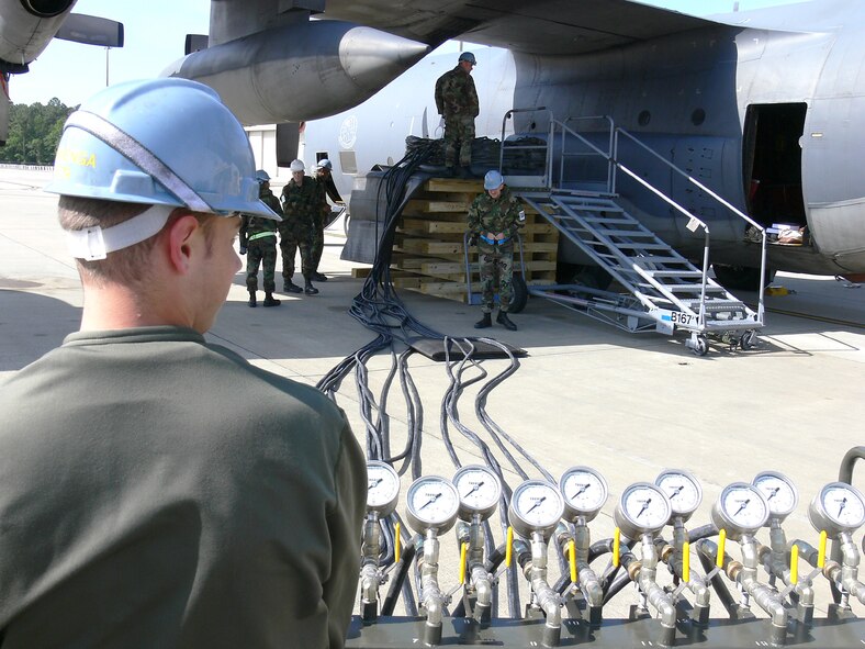 Staff Sgt. Wesley Foster, 723rd Maintenance Squadron, takes control of a pnuematic console that is connected to airlift bags located under an HC-130. This task was part of an airlift bag training simulation April 6, which helped the 723rd MXS hone an important technique of crash recovery. (U.S. Air Force photo by Airman 1st Class Eric Schloeffel)