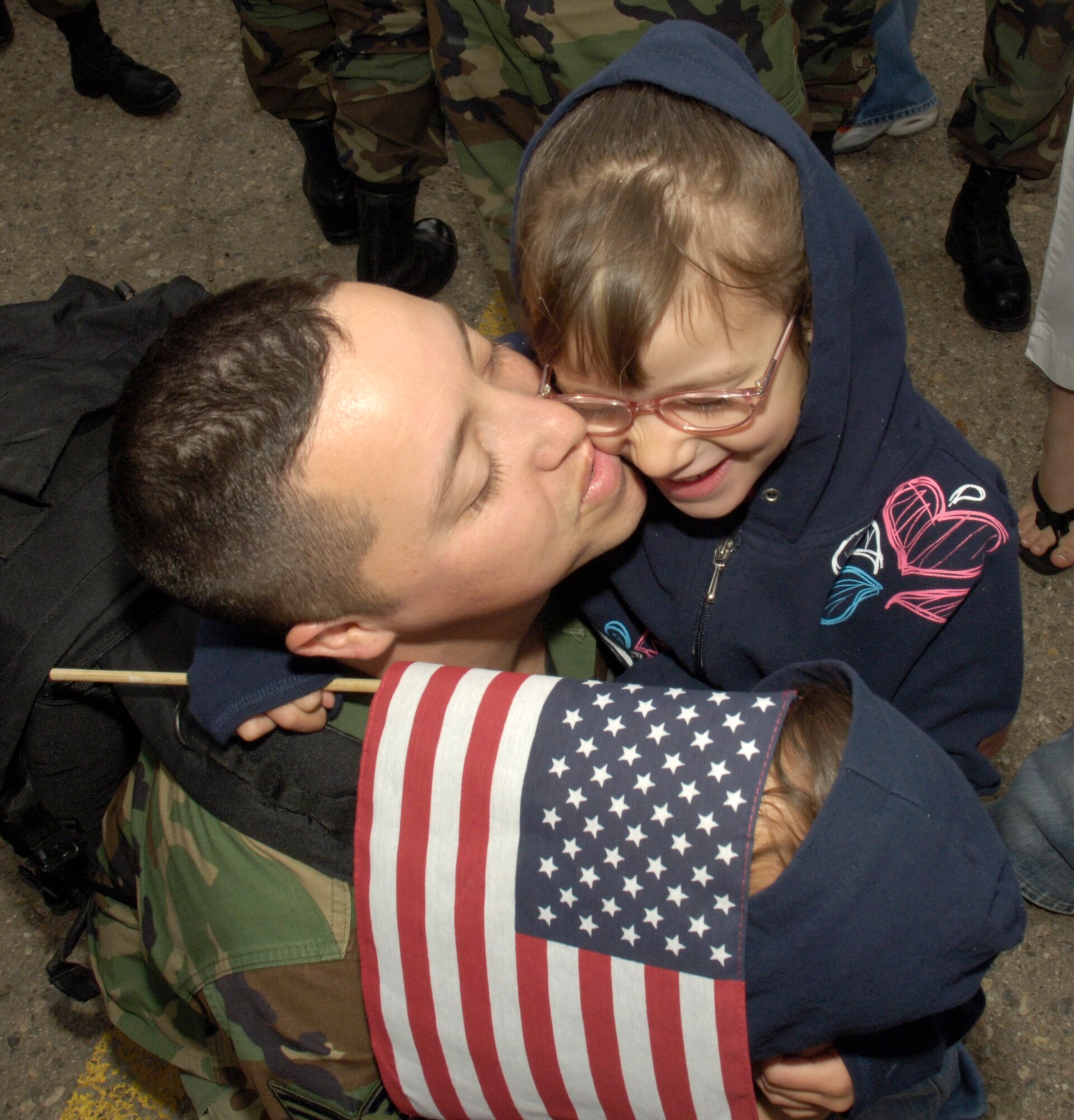 Tech. Sgt. Tony Jacquez , 49th Maintenance Squadron, hugs his children Tasha and Tiffany at Holloman Air Force Base April 13, after returning home from a three-and-ahalf-month deployment to the Republic of Korea.  (U.S. Air Force photo by Airman Michael Means)