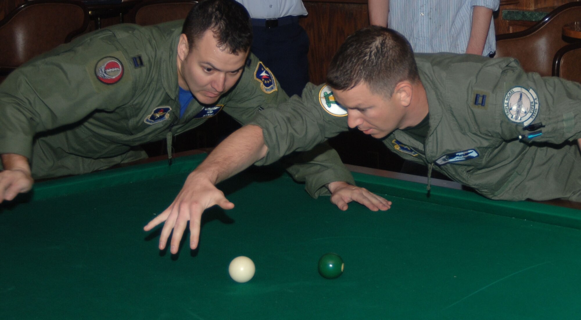 Captain Rick Shafer of the Hangmen distracts Capt. Matt Edwards of the Trunk Monkeys as he moves in for the shot. The fifth Blazing Balls of O'Leary crud tournament was held Friday night at the Columbus Club.  Ten teams participated resulting in an intense, multi-hour tournament.  The Hangmen of the 49th Fighter Training Squadron took the trophy home after defeating the Trunk Monkeys, a team of 14th Flying Training Wing instructor pilots.