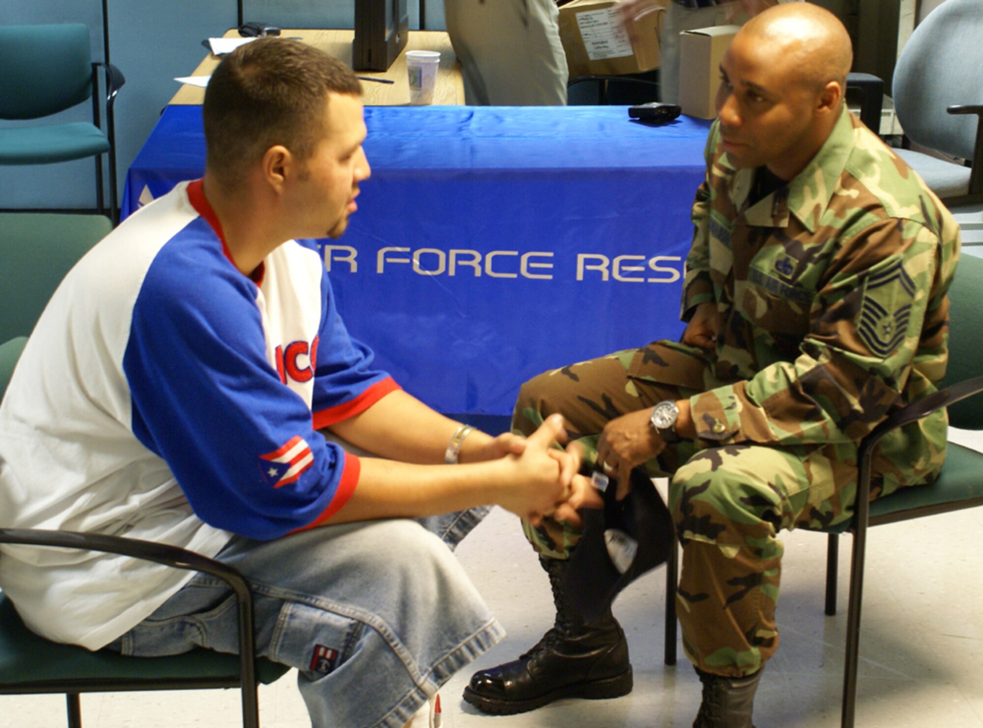Jordan Roman, a former crew chief and senior airman, talks with Senior Master Sgt. Katdo Robinson during an Individual Ready Reserve muster at Homestead Air Reserve Base April 14.  Sergeant Robinson represents the 482nd Maintenance Group, and was on hand to provide vets with information about job opportunities at Homestead ARB.  Mr. Roman is one of approximately 80 former service members who reported to the base for the annual muster, which gave them the opportunity to receive updated information about the military while fulfilling their obligation to keep their military records updated. (U.S. Air Force photo/Jake Shaw)