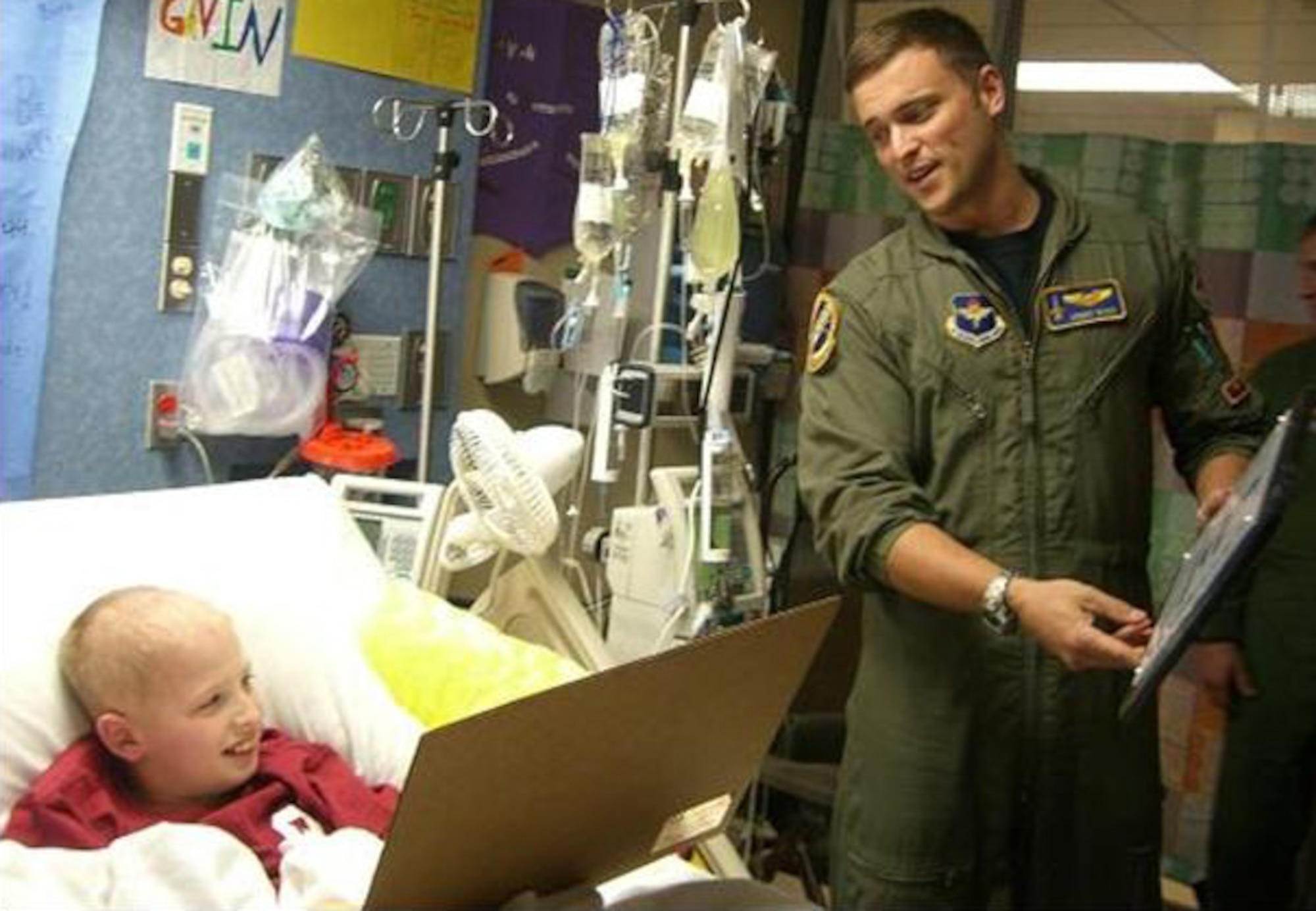 Capt. Jonathan Burd, 25th Flying Training Squadron instructor pilot, presents Gavin Zelnicek with a T-38 lithograph and certificate designating the 5th grader from Hennessey, Okla., a 71st Flying Training Wing honorary pilot. A contingent of 25th FTS IPs paid a surprise visit to Gavin, diagnosed with acute myeloid leukemia, who has always wanted to be a pilot. In addition to the litho and certificate, the 25th Shooters presented the young man with a wide array of honors, including a wing coin and honorary pilot certificate signed by Col. Richard Klumpp, Jr., 71st FTW commander. Photo courtesy of Amber Burd
