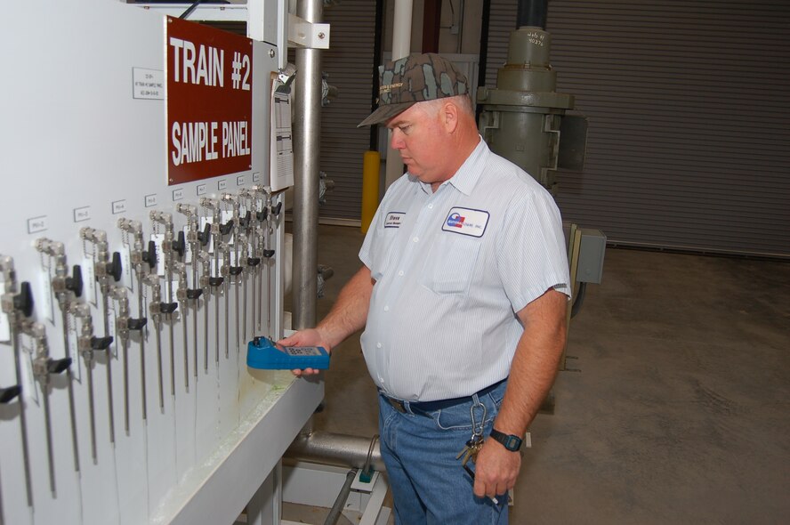 Steve Stalvey, water and wastewater site manager for National O&M Inc., takes a water sample at the water nanofiltration plant here April 10. The plant produces an average of 300,000 gallons of fresh water daily for the base. (U.S. Air Force photo by Tech. Sgt. Parker Gyokeres)