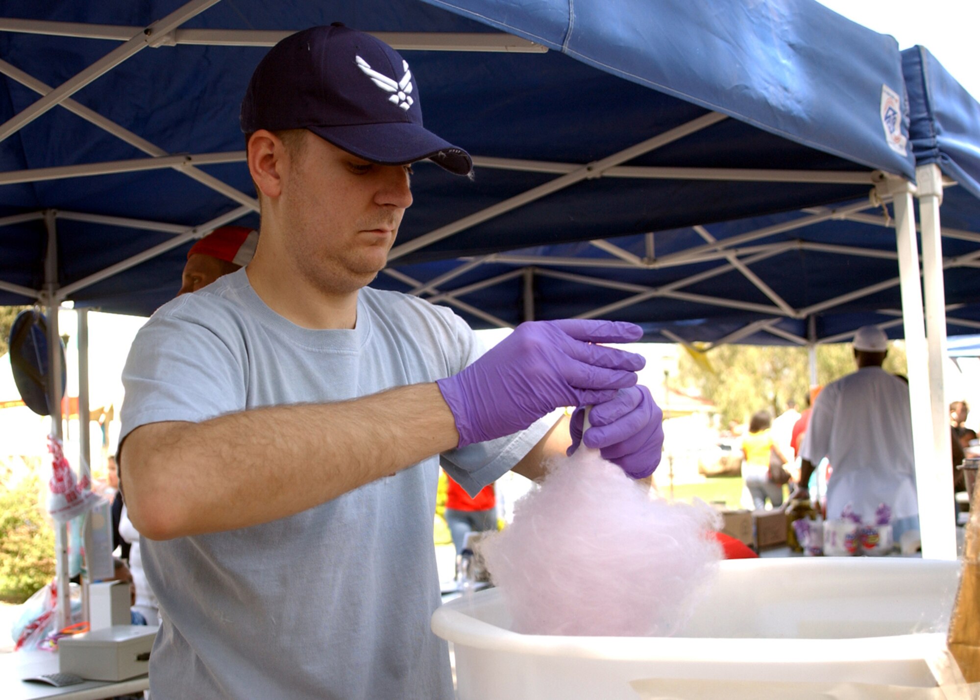 Senior Airman Russell Cihal, 39 Communications Squadron, prepares cotton candy at the Spring Fling on April 14.  The Spring Fling was held at Arkadas Park and included pony rides, face painting, food booths, and games.  (U.S. Air Force photo by Airman First Class Tiffany A. Colburn)