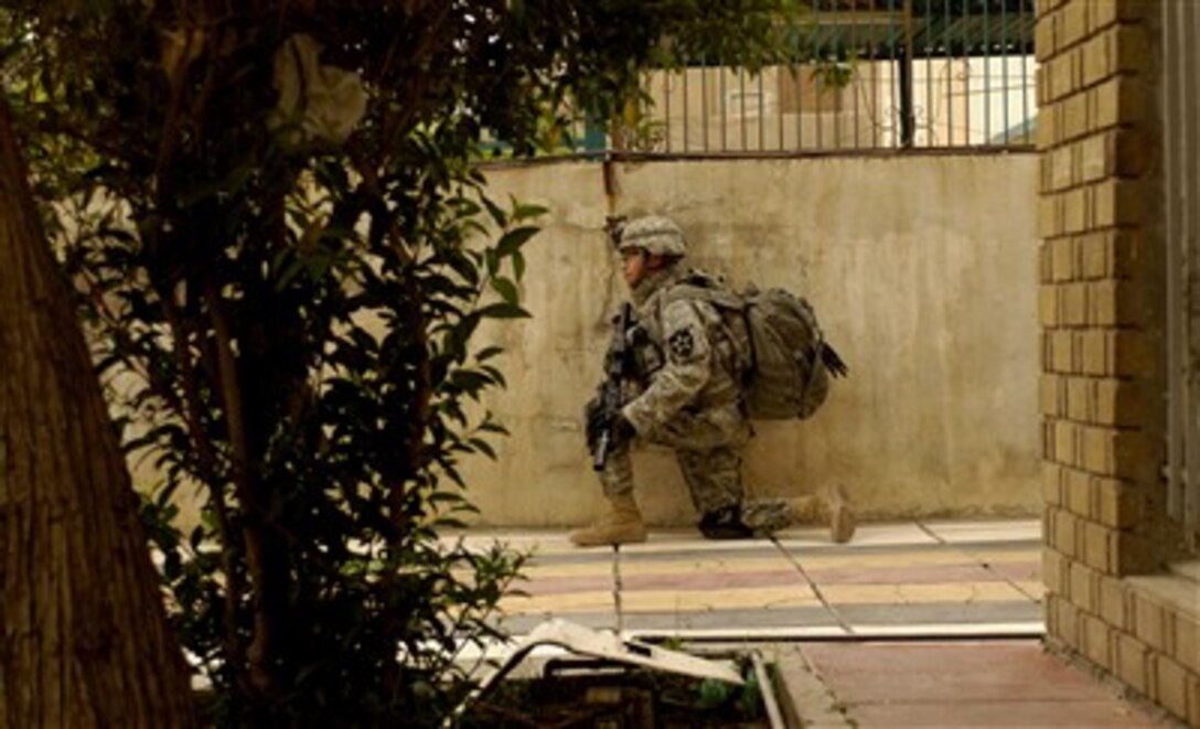 U.S. Army Spc. Omar Herrera provides security during a joint foot patrol led by the Iraqi army from the 1st Platoon, 1st Company, 1st Battalion, 5th Brigade, 6th Iraqi Army Division, in Baghdad, Iraq, April 10, 2007. Herrera is assigned to the 3rd Platoon Alpha Company, 2nd Battalion, 3rd Infantry Regiment, 3rd Stryker Brigade Combat Team, 2nd Infantry Division, Fort Lewis, Wash.