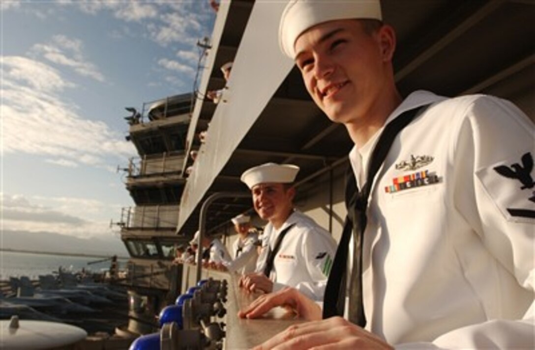 U.S. Navy sailors man the rails as the aircraft carrier USS Ronald Reagan (CVN 76) pulls into Naval Station Pearl Harbor, Hawaii, for a port visit on April 9, 2007.  