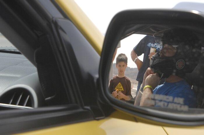 Ray Berlo, a drifting performer and the owner and driver of the 2002 Lexus IS 300, puts on his gear before a practice drift on the flightline in preparation for the Autocross speed competition April 14, 2007 on Nellis Air Force Base, Nevada. (U.S. Air Force Photo/Senior Airman Larry Reid Jr.)
