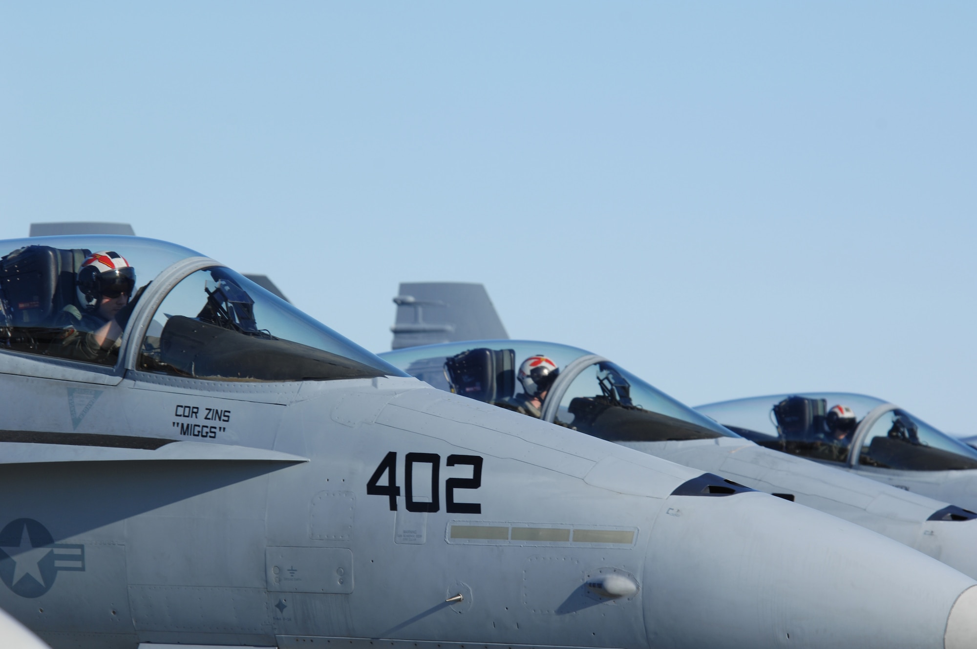 EIELSON AIR FORCE BASE, Alaska -- Three Navy F/A-18 pilots from Strike Fighter Squadron Eight Seven (VFA-87) wait to taxi on the flightline here during Red Flag-Alaska 07-1. VFA-87 is home based at Naval Air Station Oceana, Virginia. Red Flag-Alaska is a Pacific Air Forces-directed field training exercise for U.S. forces flown under simulated air combat conditions. It is conducted on the Pacific Alaskan Range Complex with air operations flown out of Eielson and Elmendorf Air Force Bases. (U.S. Air Force Photo by Staff Sgt Joshua Strang)