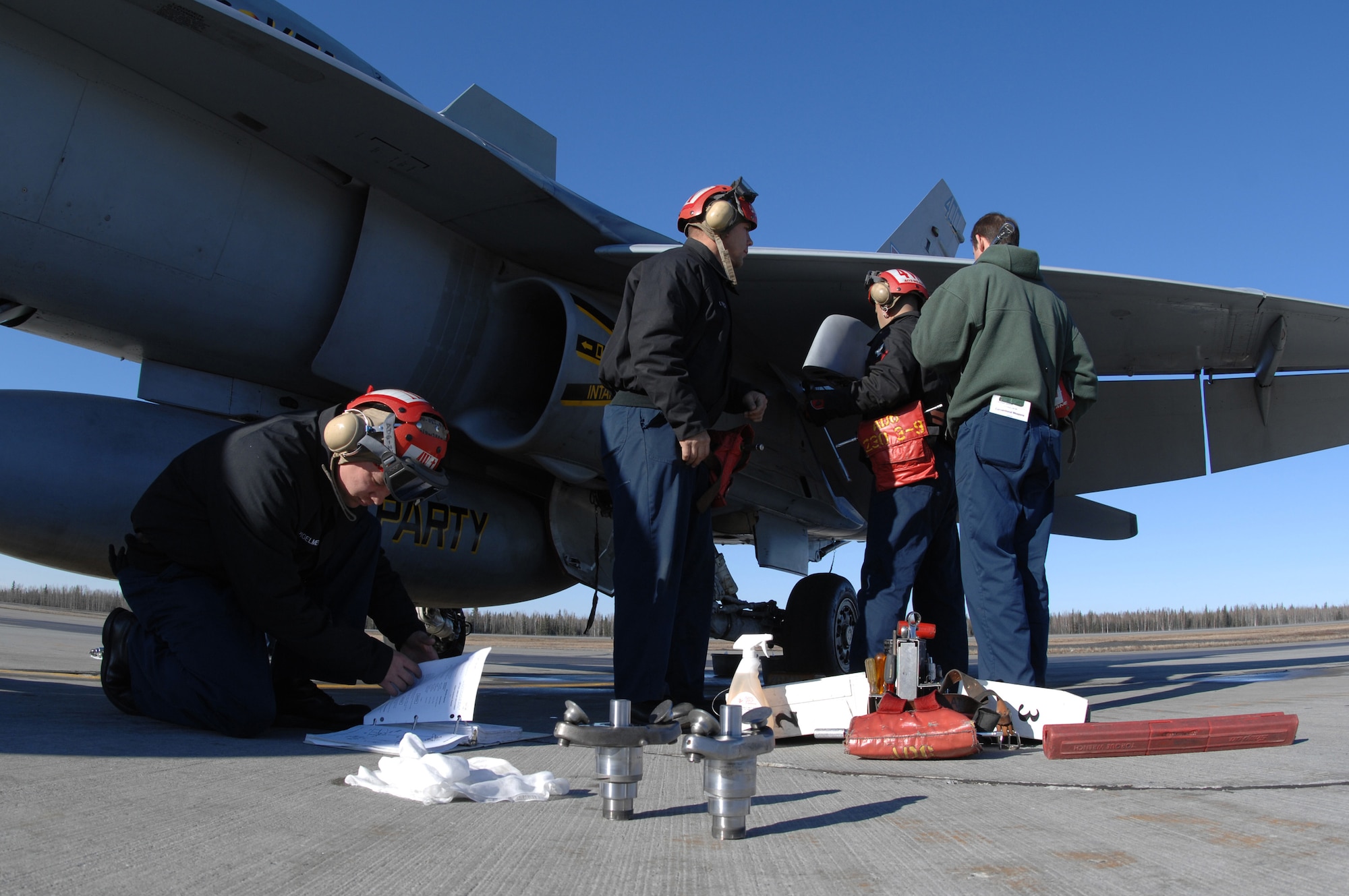 EIELSON AIR FORCE BASE, Alaska -- Members of Strike Fighter Squadron Eight Seven (VFA-87) perform maintenance on a Navy F/A-18 during Red Flag-Alaska 07-1. VFA-87 is home based at Naval Air Station Oceana, Virginia. Red Flag-Alaska is a Pacific Air Forces-directed field training exercise for U.S. forces flown under simulated air combat conditions. It is conducted on the Pacific Alaskan Range Complex with air operations flown out of Eielson and Elmendorf Air Force Bases. (U.S. Air Force Photo by Staff Sgt Joshua Strang)