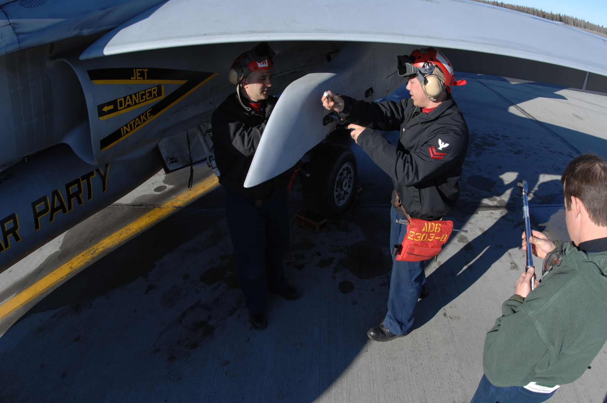 EIELSON AIR FORCE BASE, Alaska -- Members of Strike Fighter Squadron Eight Seven (VFA-87) perform maintenance on a Navy F/A-18 during Red Flag-Alaska 07-1. VFA-87 is home based at Naval Air Station Oceana, Virginia. Red Flag-Alaska is a Pacific Air Forces-directed field training exercise for U.S. forces flown under simulated air combat conditions. It is conducted on the Pacific Alaskan Range Complex with air operations flown out of Eielson and Elmendorf Air Force Bases. (U.S. Air Force Photo by Staff Sgt Joshua Strang)