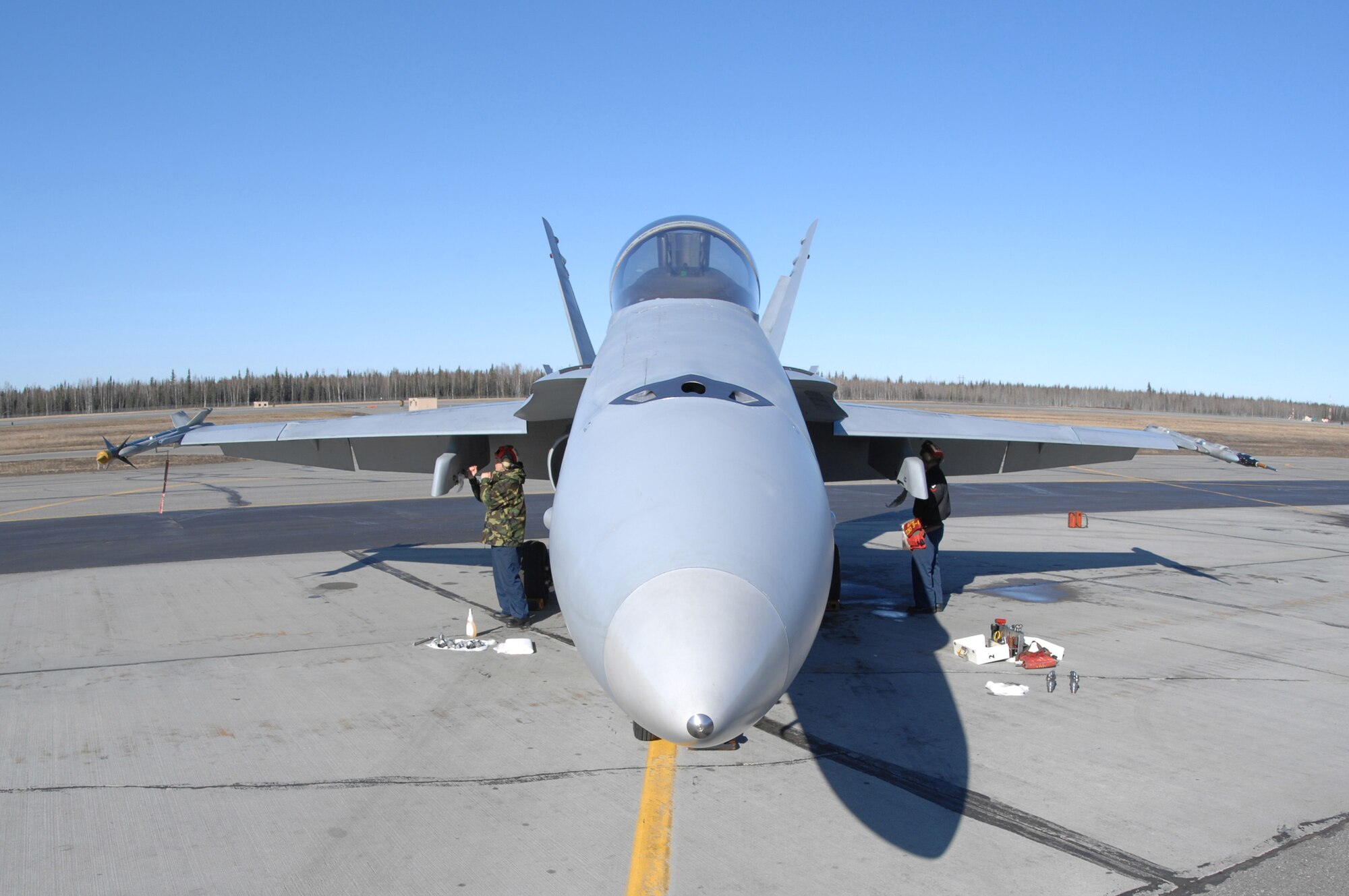 EIELSON AIR FORCE BASE, Alaska -- Two members of Strike Fighter Squadron Eight Seven (VFA-87) perform maintenance on a Navy F/A-18 during Red Flag-Alaska 07-1. VFA-87 is home based at Naval Air Station Oceana, Virginia. Red Flag-Alaska is a Pacific Air Forces-directed field training exercise for U.S. forces flown under simulated air combat conditions. It is conducted on the Pacific Alaskan Range Complex with air operations flown out of Eielson and Elmendorf Air Force Bases. (U.S. Air Force Photo by Staff Sgt Joshua Strang)