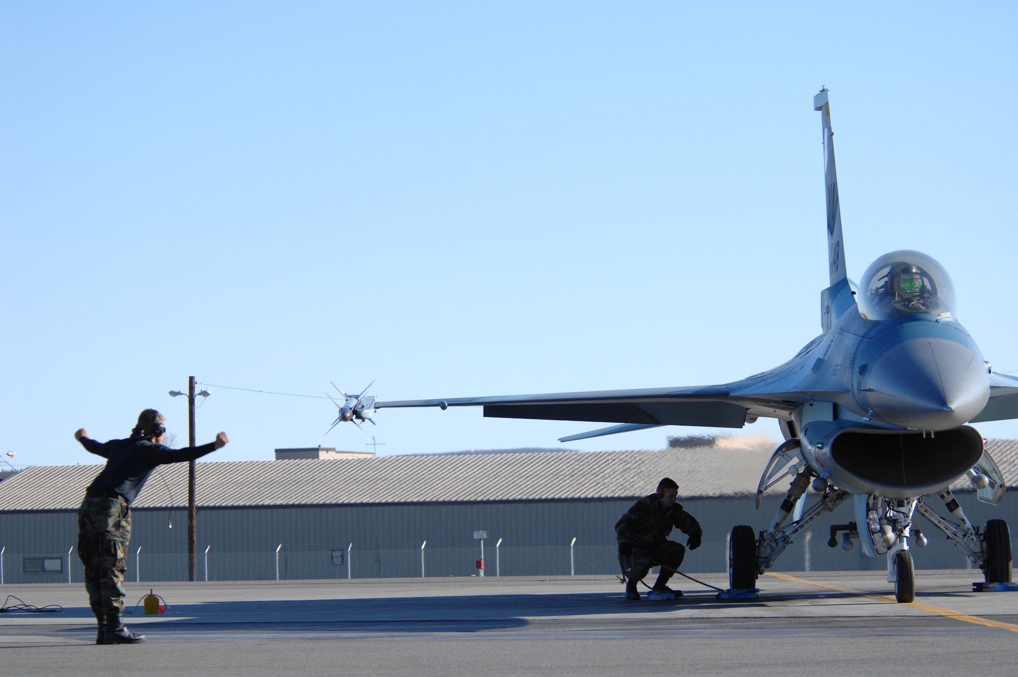 EIELSON AIR FORCE BASE, Alaska -- An F-16 Fighting Falcon crewchief from Nellis Air Force Base, Nevada signals to pull chocks during Red Flag-Alaska 07-1. Red Flag-Alaska is a Pacific Air Forces-directed field training exercise for U.S. forces flown under simulated air combat conditions. It is conducted on the Pacific Alaskan Range Complex with air operations flown out of Eielson and Elmendorf Air Force Bases. (U.S. Air Force Photo by Staff Sgt Joshua Strang)