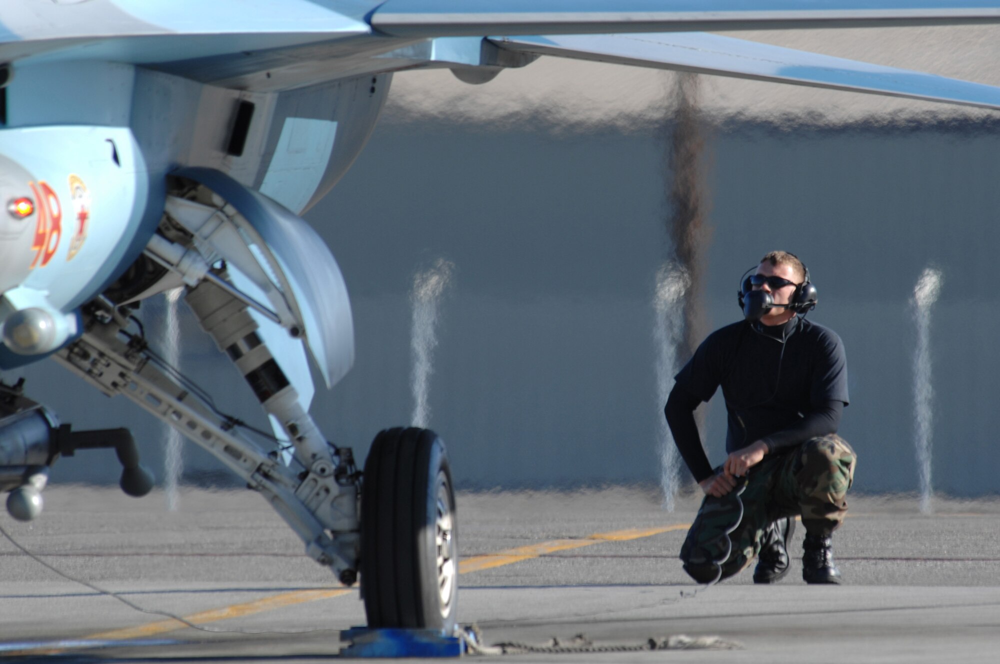 EIELSON AIR FORCE BASE, Alaska -- An F-16 Fighting Falcon crew chief from Nellis Air Force Base, Nevada inspects the tail portion of the aircraft prior to a mission during Red Flag-Alaska 07-1. Red Flag-Alaska is a Pacific Air Forces-directed field training exercise for U.S. forces flown under simulated air combat conditions. It is conducted on the Pacific Alaskan Range Complex with air operations flown out of Eielson and Elmendorf Air Force Bases. (U.S. Air Force Photo by Staff Sgt Joshua Strang)