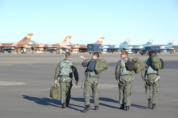 EIELSON AIR FORCE BASE, Alaska -- Four F-16 Fighting Falcon pilots from the 64th Aggressor Squadron, Nellis Air Force Base, Nevada look at the French Mirage2000 aircraft as they step to their jets prior to a mission during Red Flag-Alaska 07-1. Red Flag-Alaska is a Pacific Air Forces-directed field training exercise for U.S. forces flown under simulated air combat conditions. It is conducted on the Pacific Alaskan Range Complex with air operations flown out of Eielson and Elmendorf Air Force Bases. (U.S. Air Force Photo by Staff Sgt Joshua Strang)