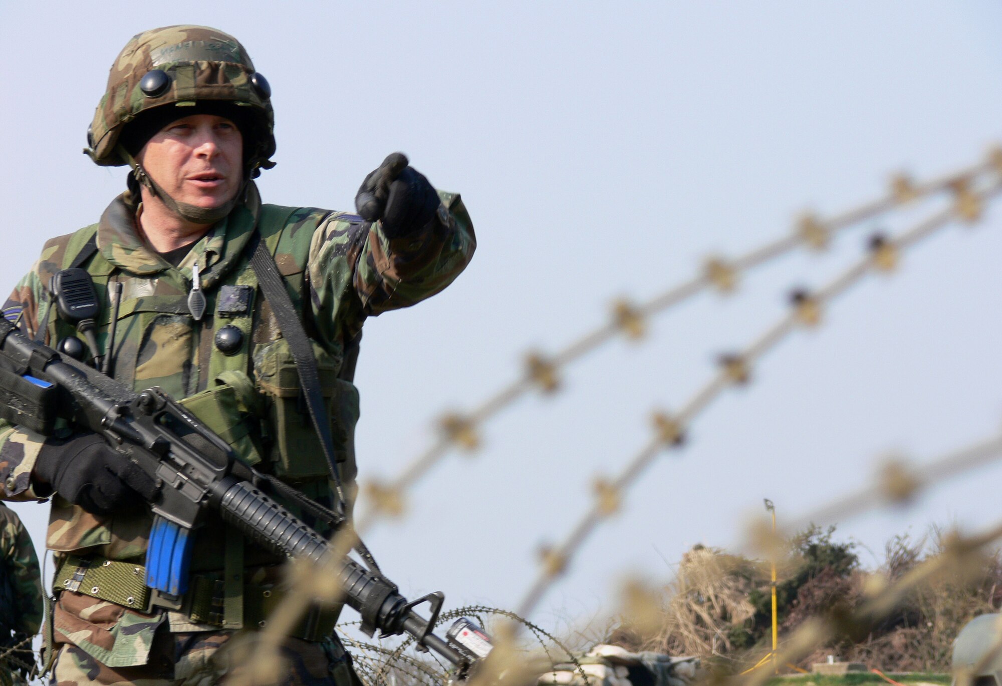 Staff Sgt. Leslie Jimerson calls out approaching locals during a field training exercise in Bitburg, Germany. Different scenarios were thrown at the 1st Combat Communications team to ensure they understood and applied the knowledge needed to handle noncompliant individuals downrange. Sergeant Jimerson is a 1st CC technical controller. (U.S. Air Force photo/Staff Sgt. Jeremy Hostetter)Hostetter.)